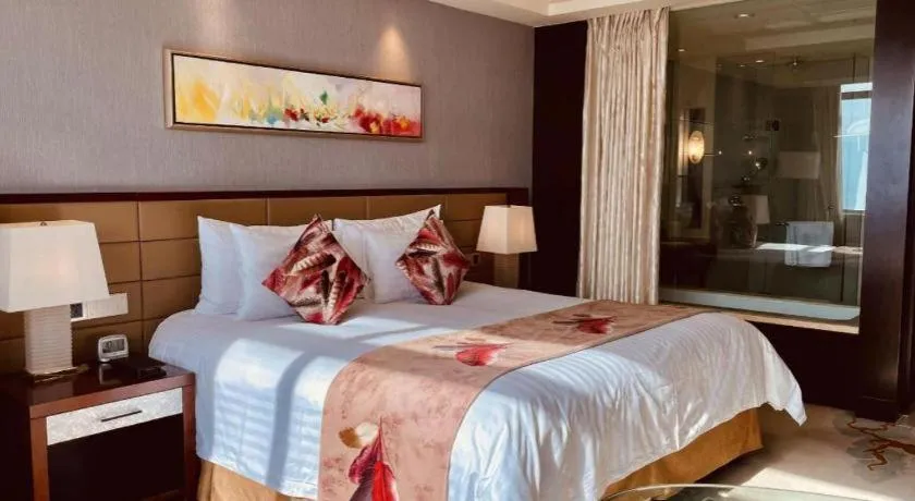 Bed in New Century Grand Hotel Lishui Huaqiao