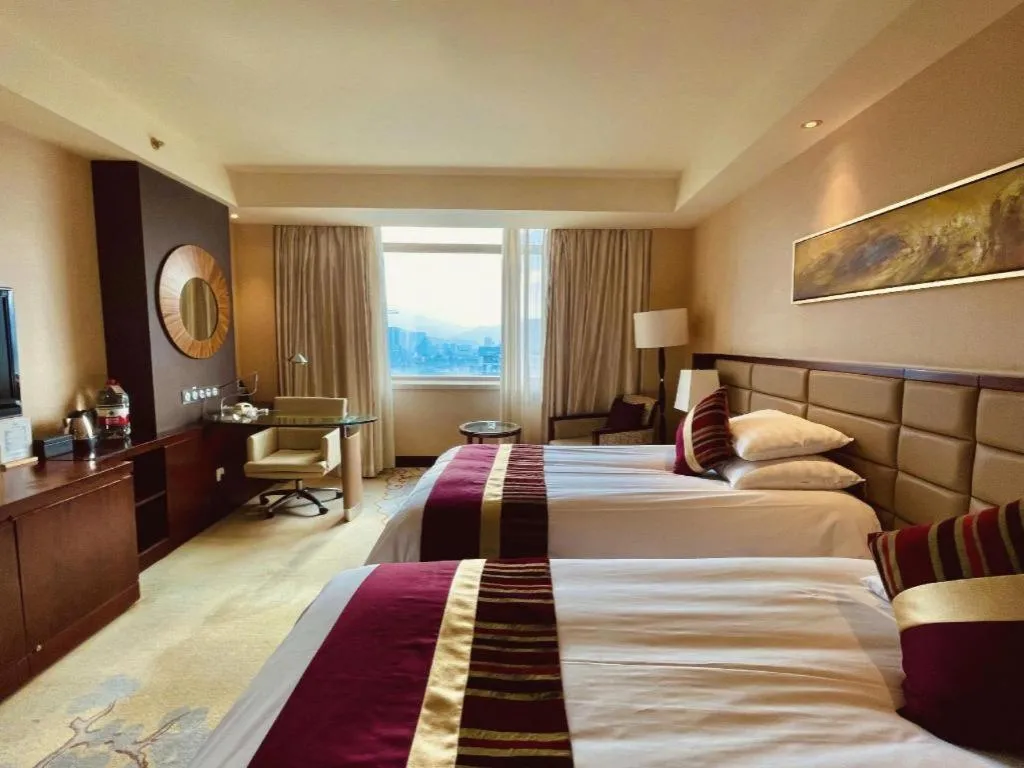 Bed in New Century Grand Hotel Lishui Huaqiao