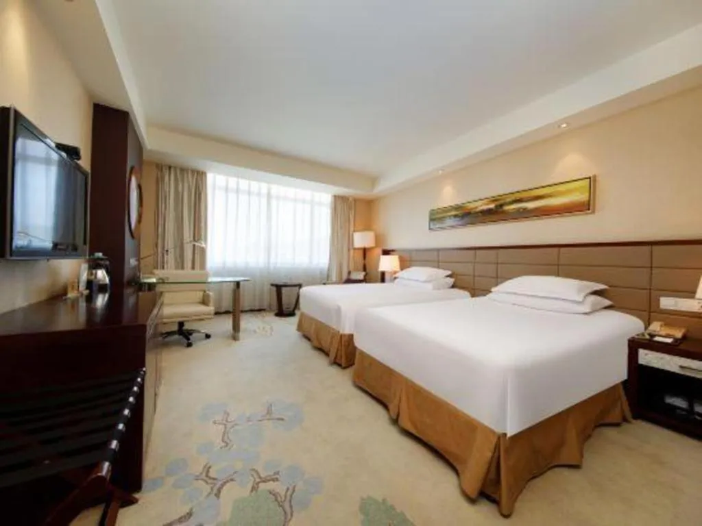 Bed in New Century Grand Hotel Lishui Huaqiao