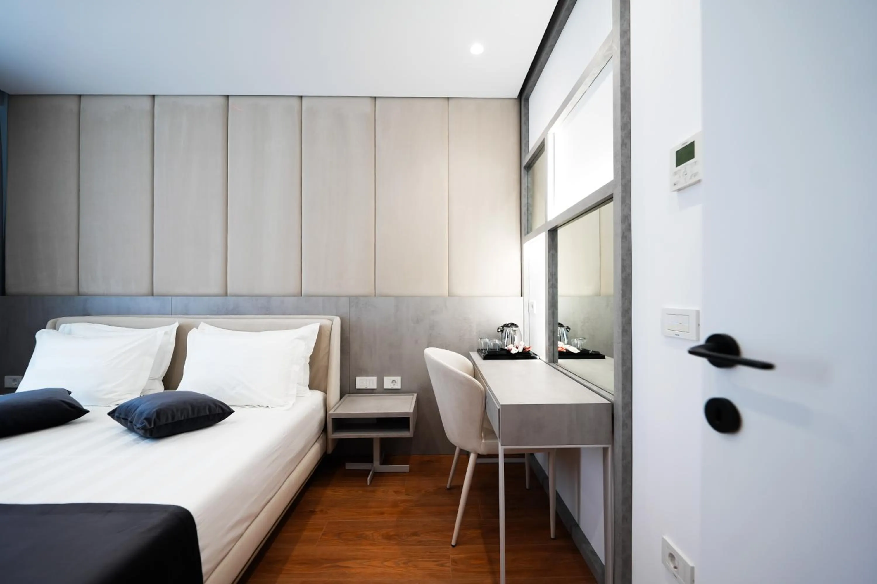 Bed in Naos Luxury Hotel