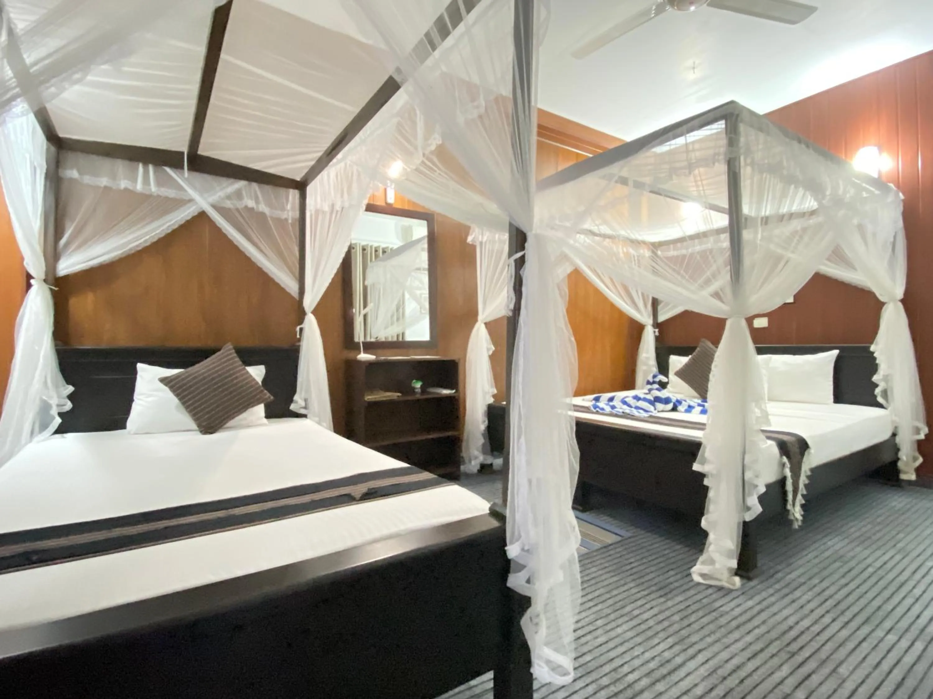 Bed in Coco Palm Villa and Cabanas