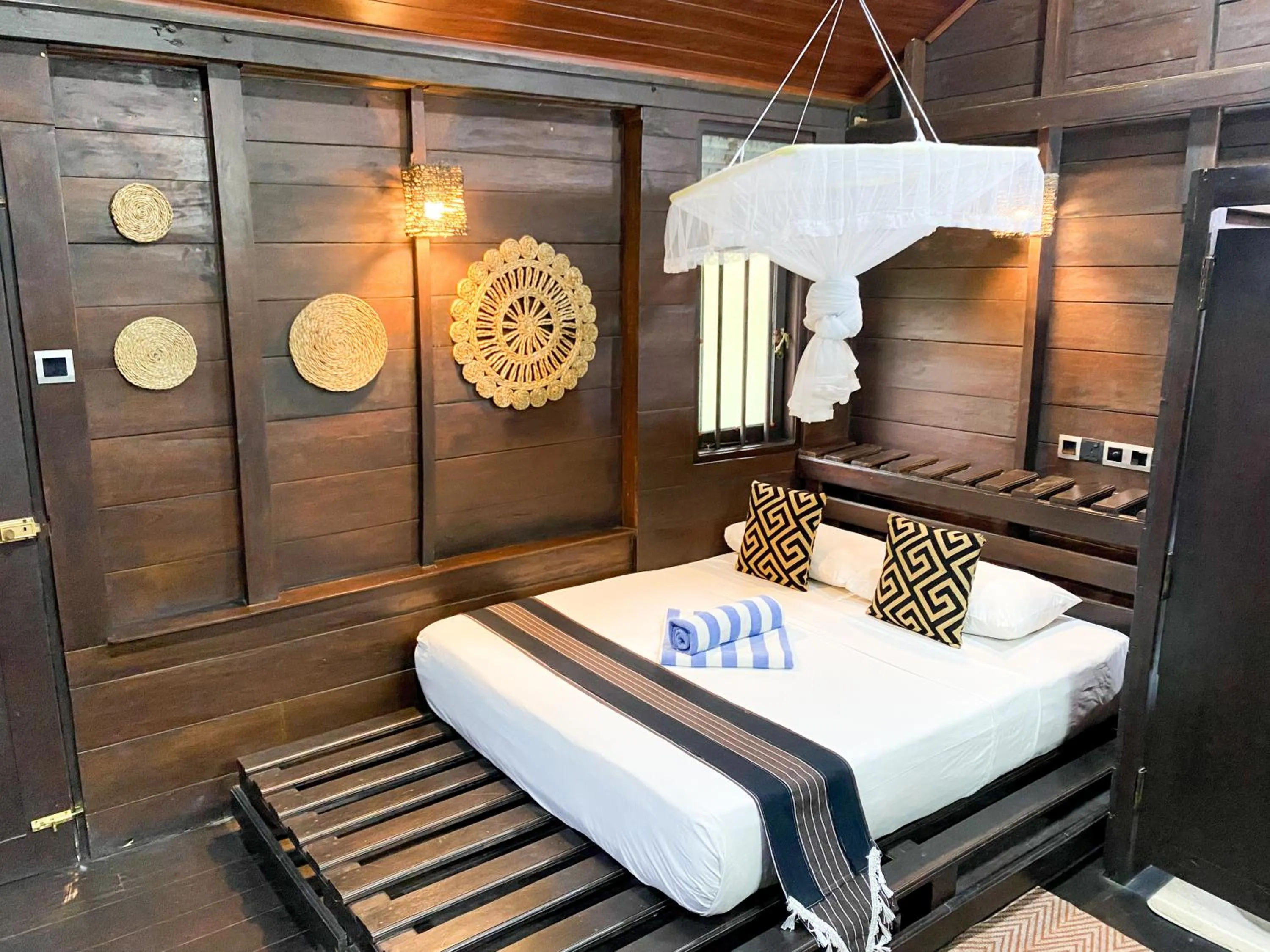 Bed in Coco Palm Villa and Cabanas