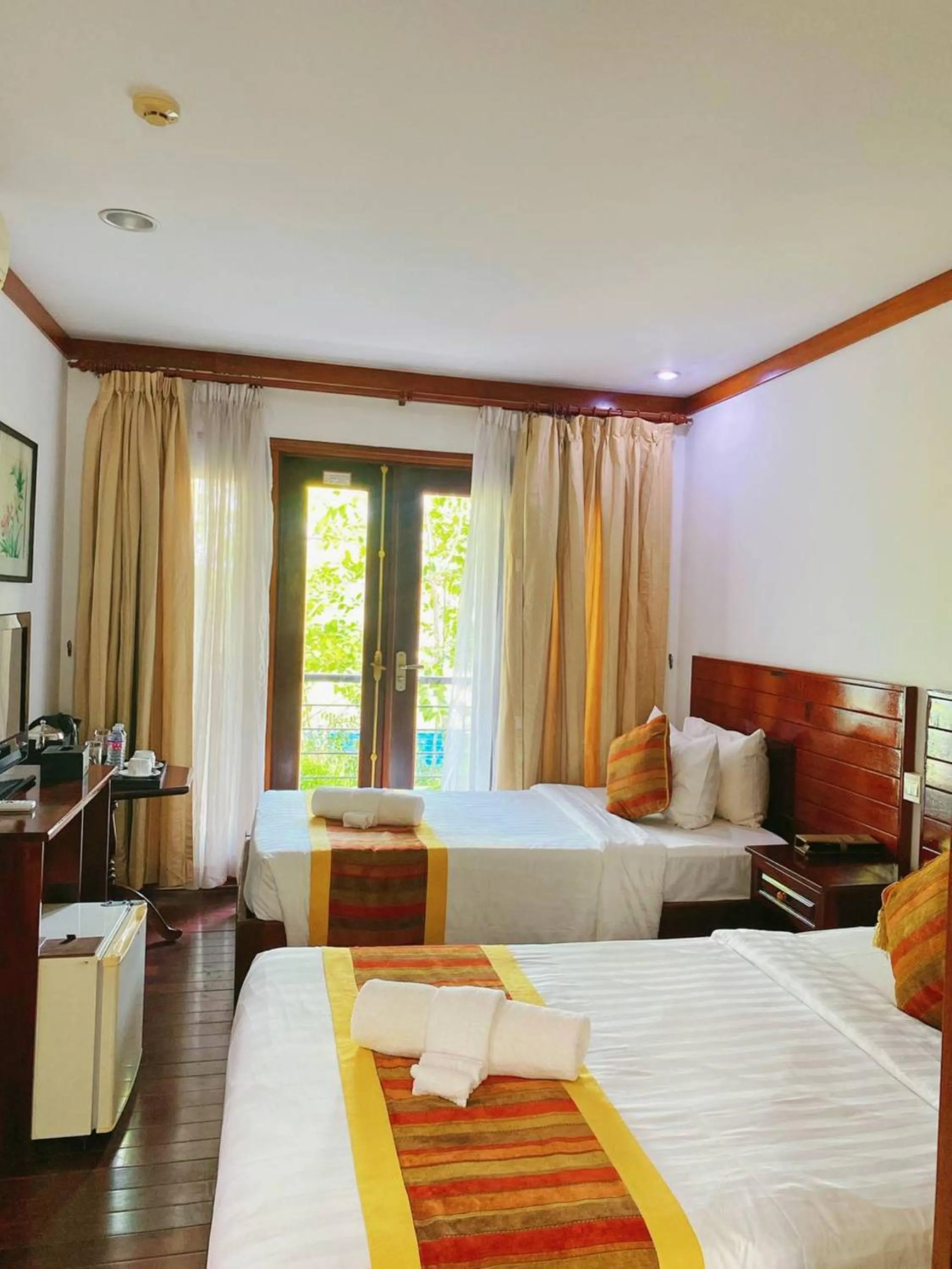 Bed in EG Paradise Angkor Villa Hotel