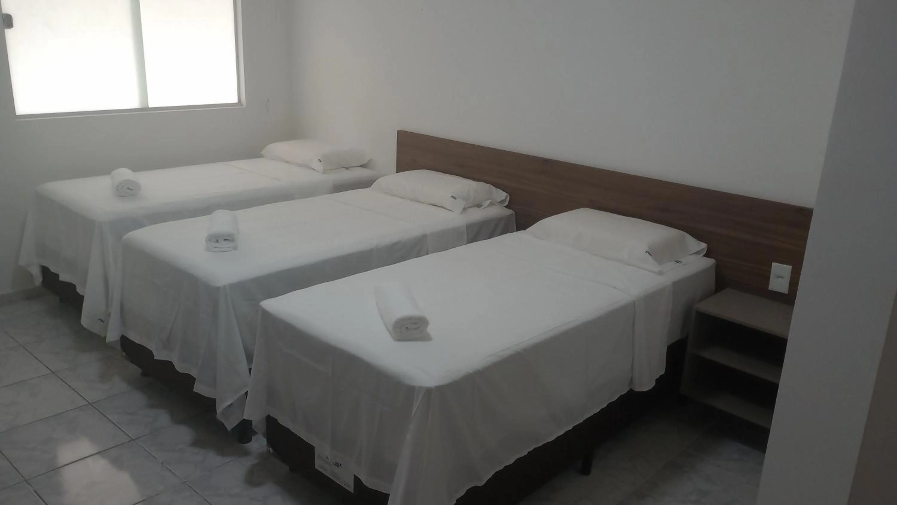 Bed in PARALELO 9s HOTEL