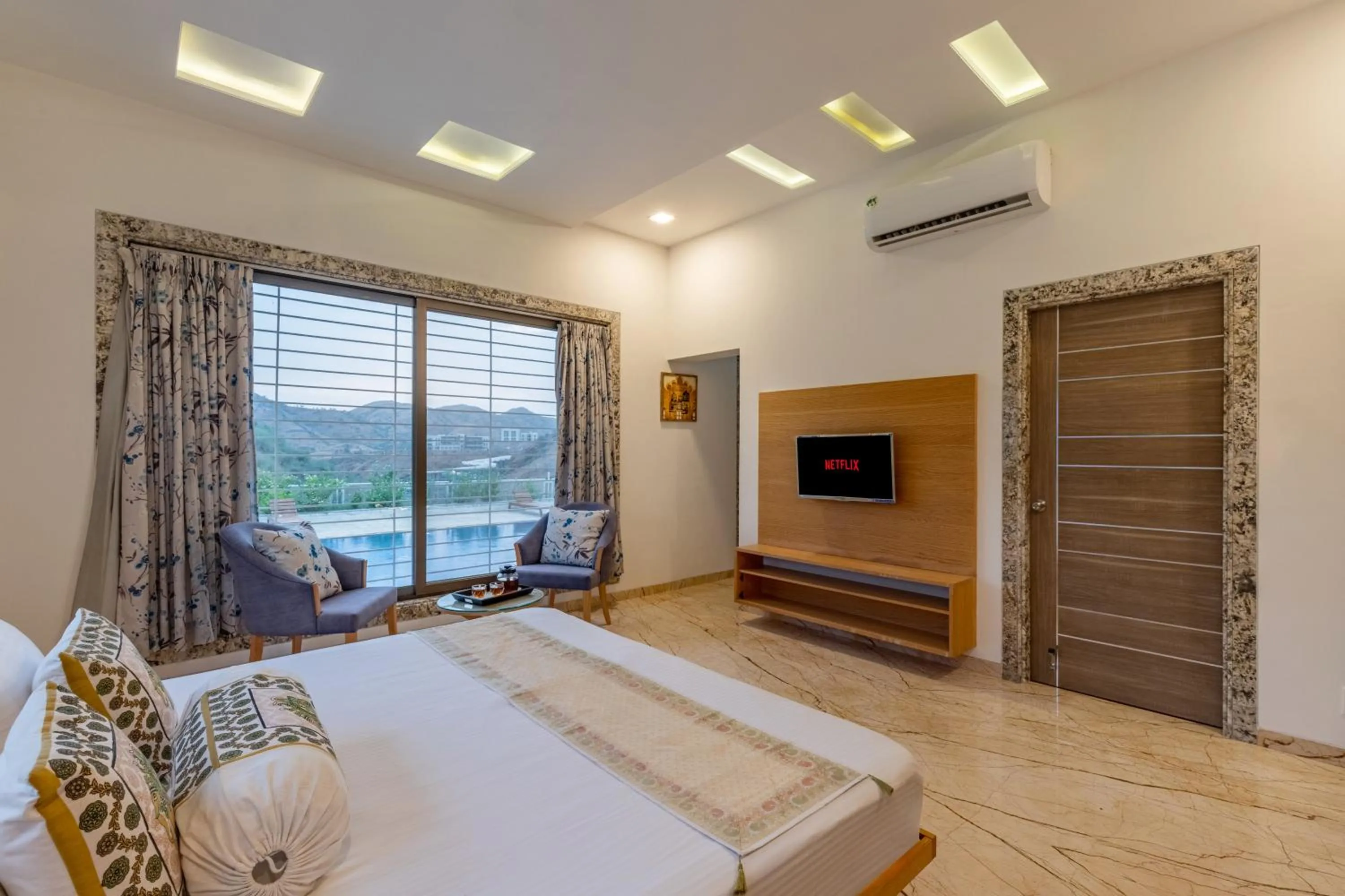 Bed in ELIVAAS Shourya Celesta Luxe 3BHK Villa with Pvt Pool, Udaipur