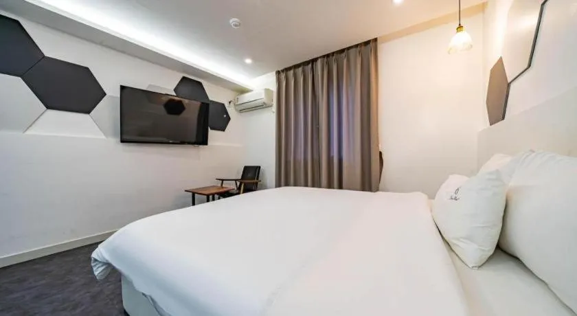 Bed in Gray Hotel