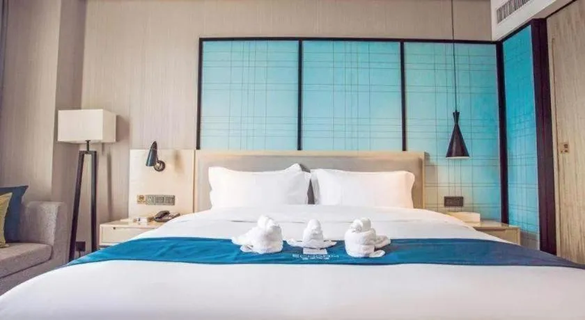 Bed in Echarm Hotel Qionghai Wanquan River