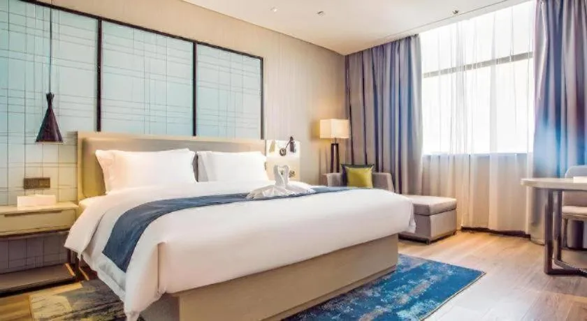 Bed in Echarm Hotel Qionghai Wanquan River