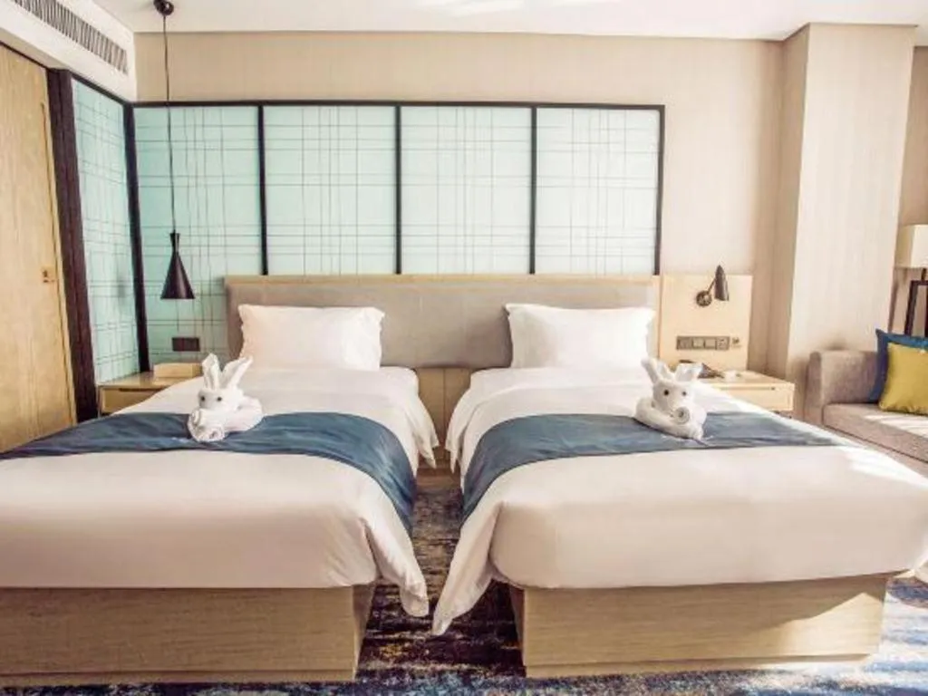 Bed in Echarm Hotel Qionghai Wanquan River