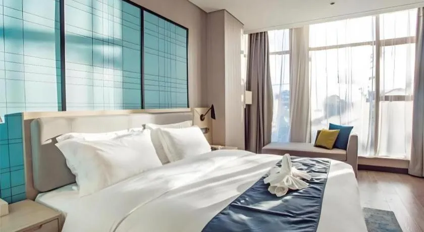 Bed in Echarm Hotel Qionghai Wanquan River