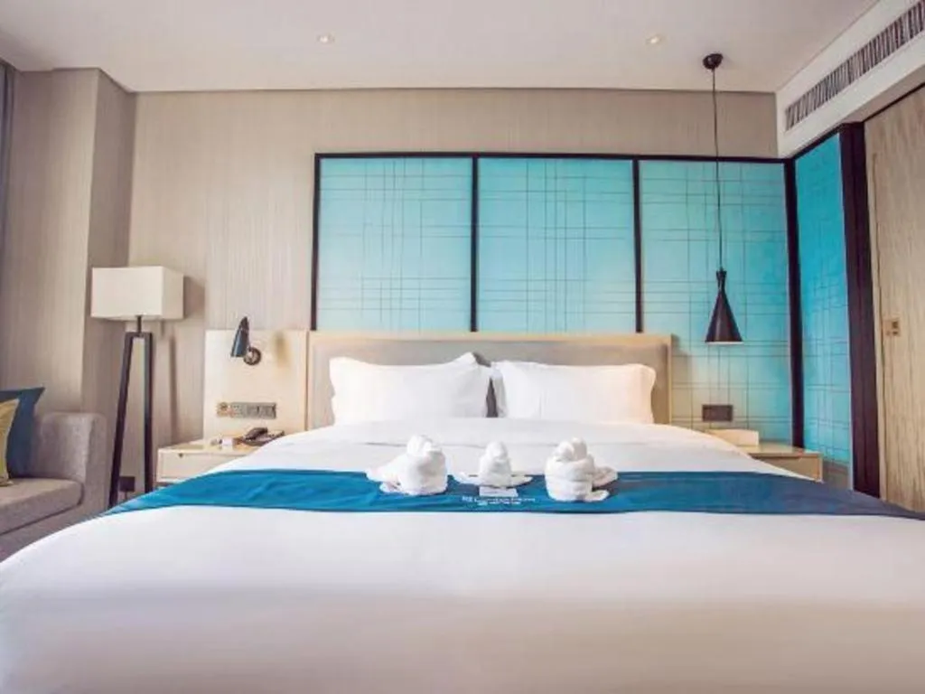 Bed in Echarm Hotel Qionghai Wanquan River