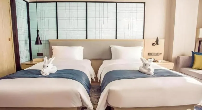 Bed in Echarm Hotel Qionghai Wanquan River