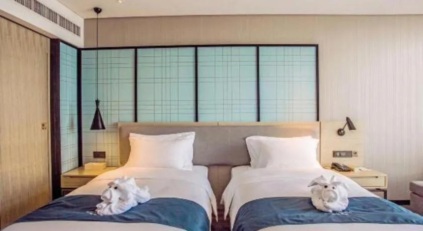 Bed in Echarm Hotel Qionghai Wanquan River