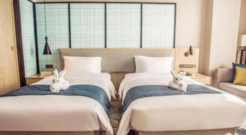 Bed in Echarm Hotel Qionghai Wanquan River