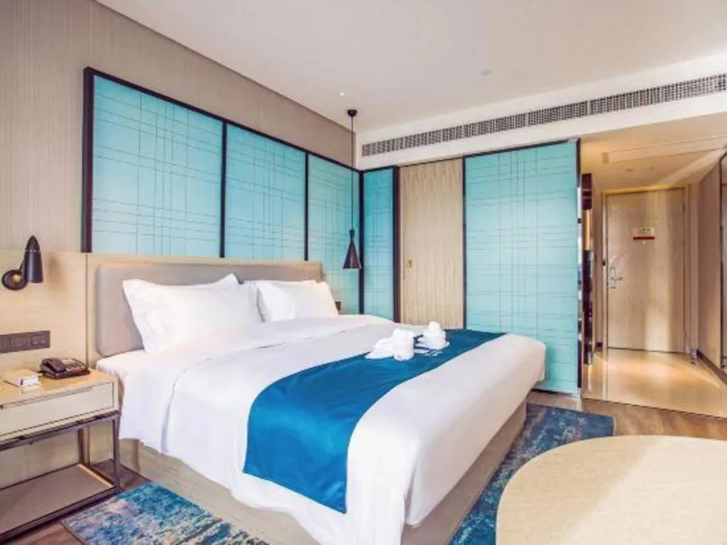 Bed in Echarm Hotel Qionghai Wanquan River