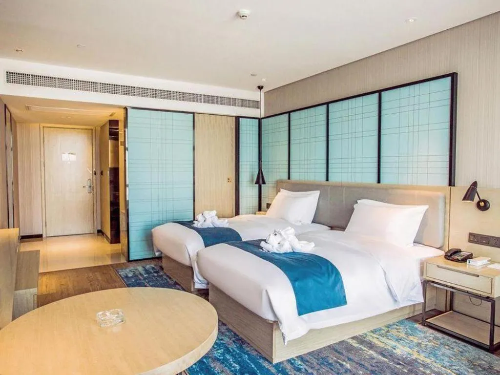 Bed in Echarm Hotel Qionghai Wanquan River