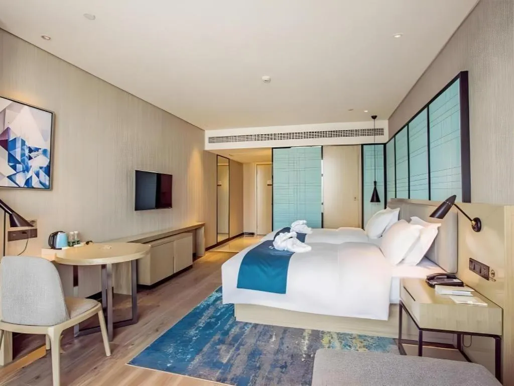Bed in Echarm Hotel Qionghai Wanquan River