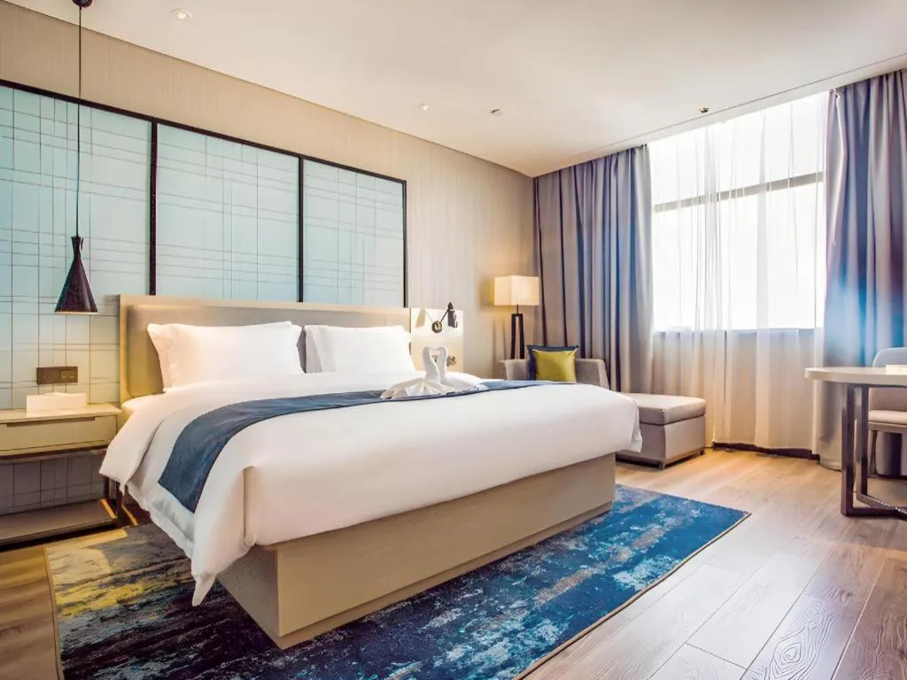 Bed in Echarm Hotel Qionghai Wanquan River