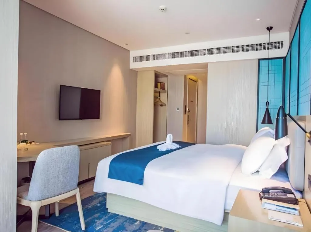 Bed in Echarm Hotel Qionghai Wanquan River