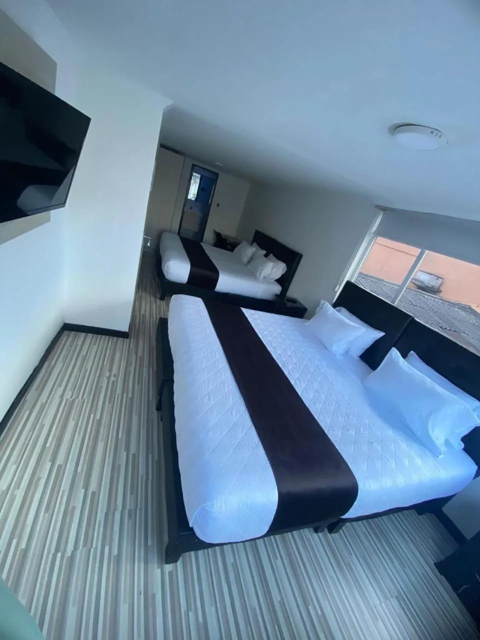 Communal lounge/ TV room, Bed in Hotel AMBAR KING