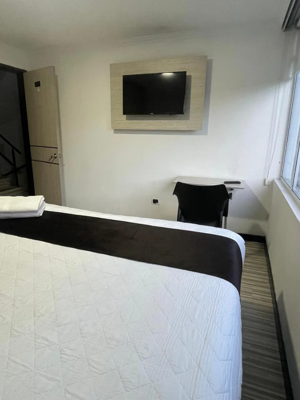 Communal lounge/ TV room, Bed in Hotel AMBAR KING