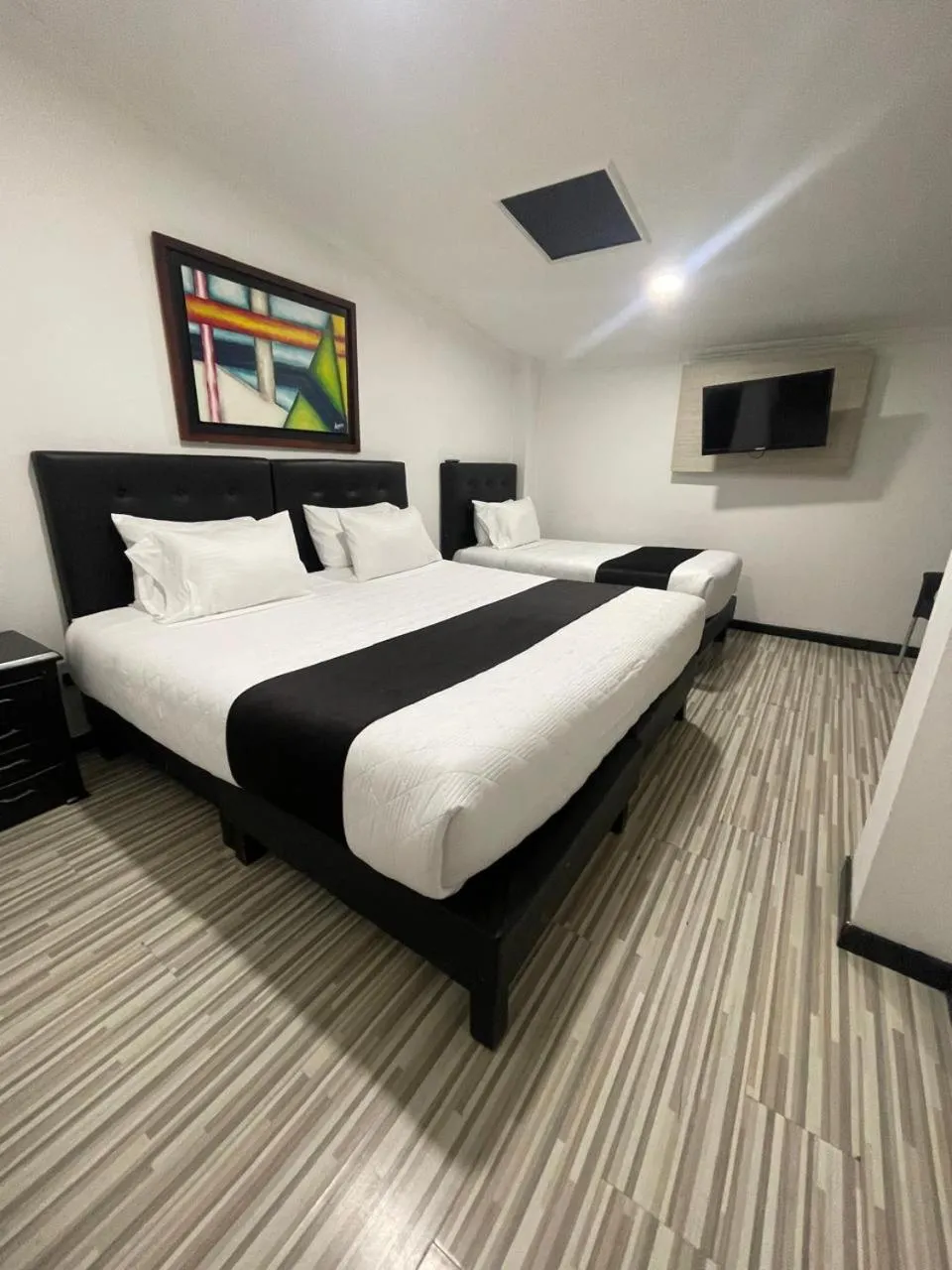 Communal lounge/ TV room, Bed in Hotel AMBAR KING