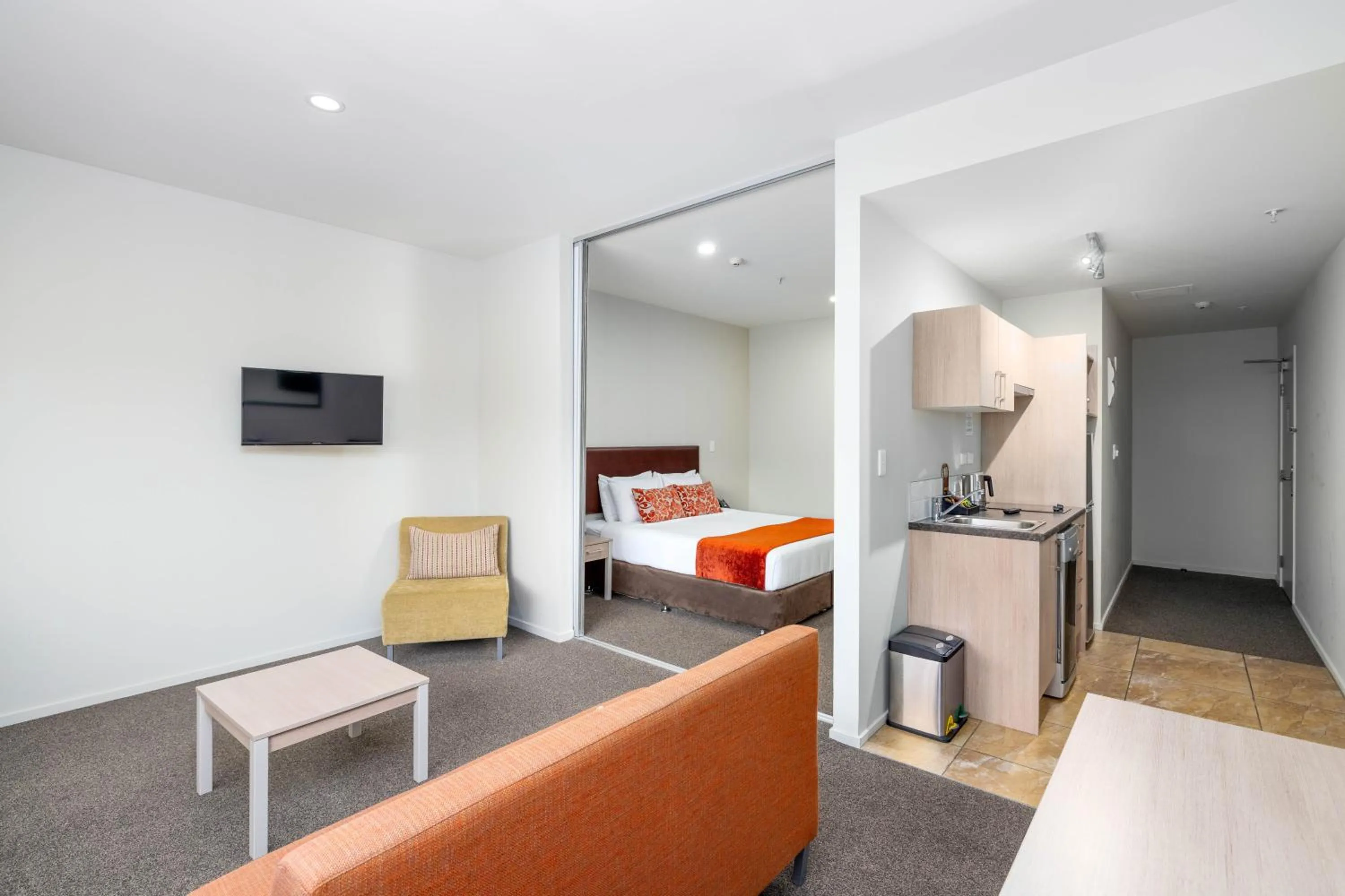 Living room, Bed in Ramada Suites by Wyndham Christchurch City