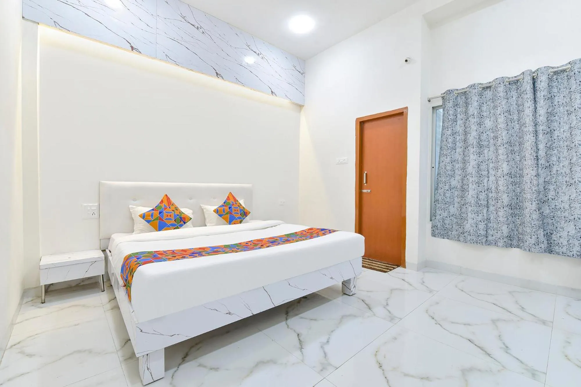 Bed in FabHotel Grand Embassy