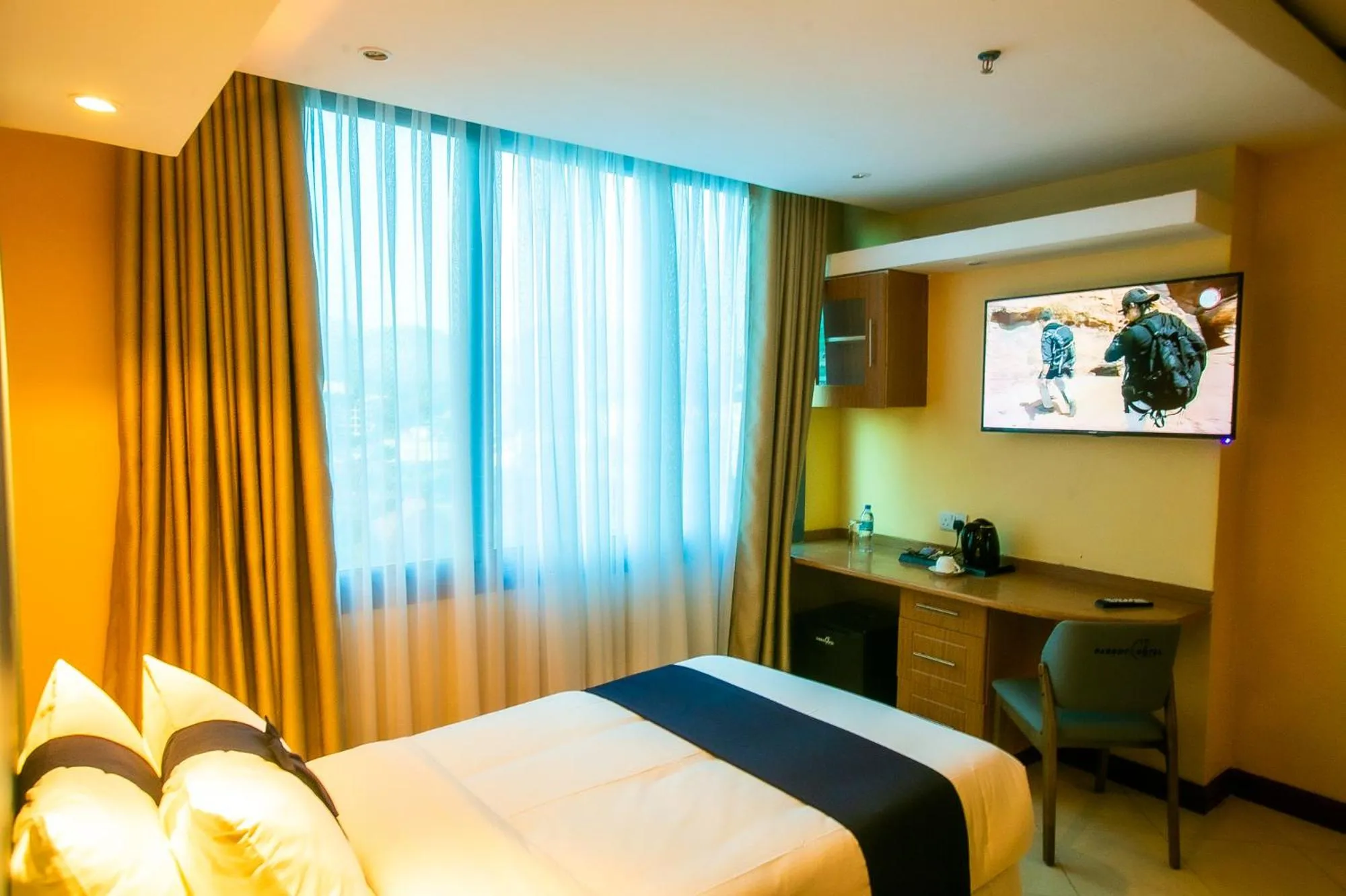 Bed in Parrot Hotel Arusha