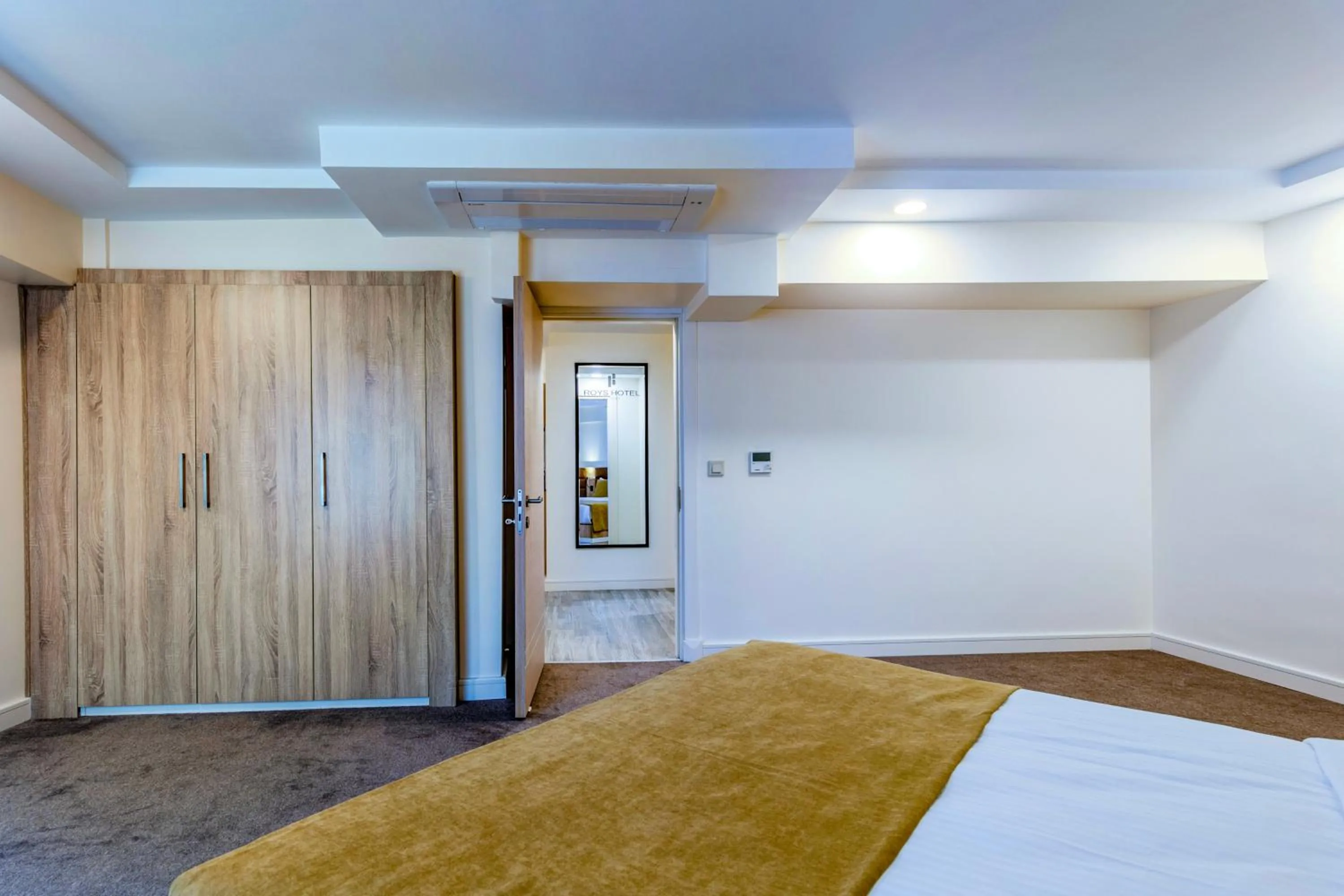 Bed in Roys Hotel & Suites