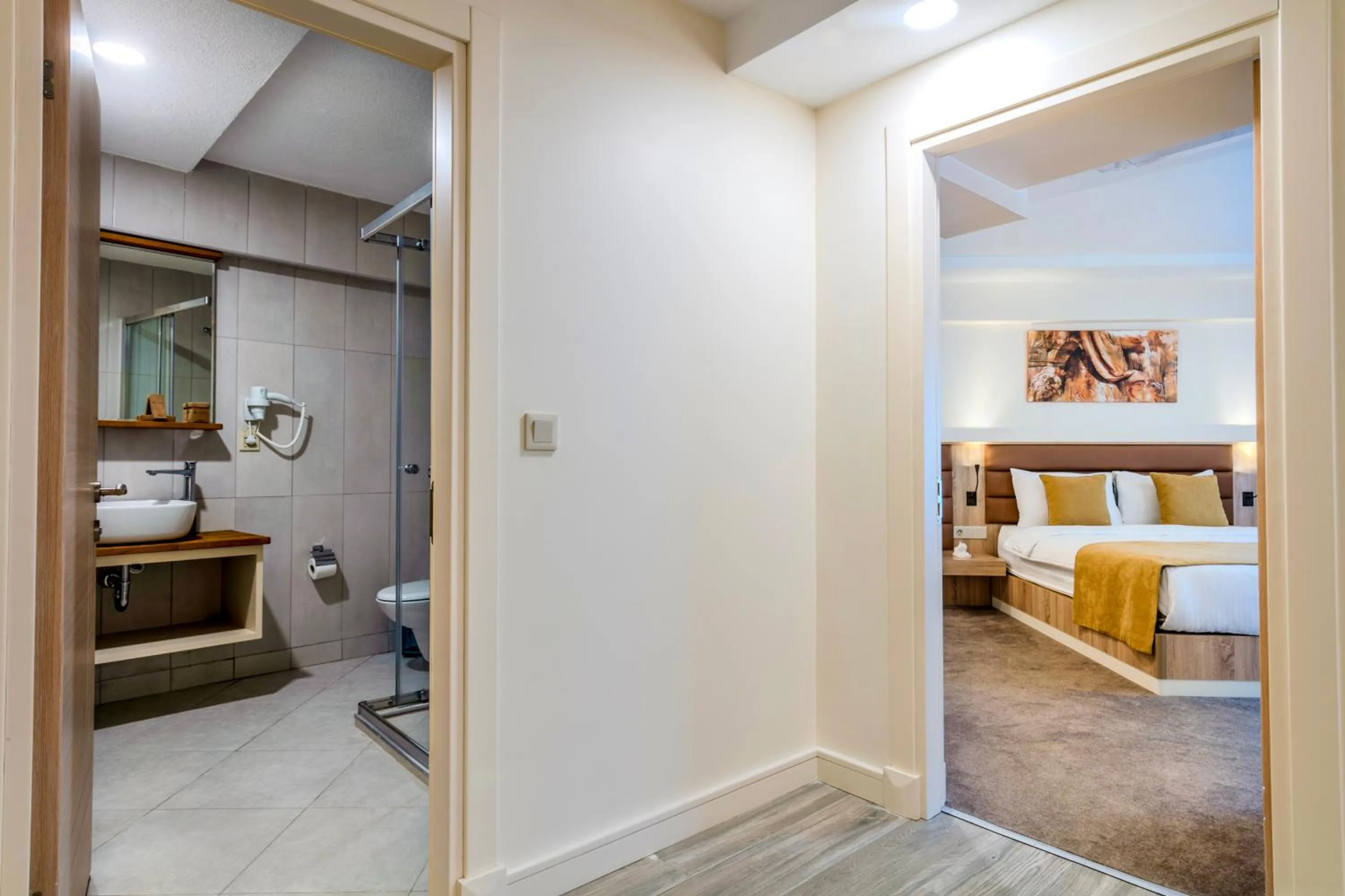 Toilet, Bed in Roys Hotel & Suites