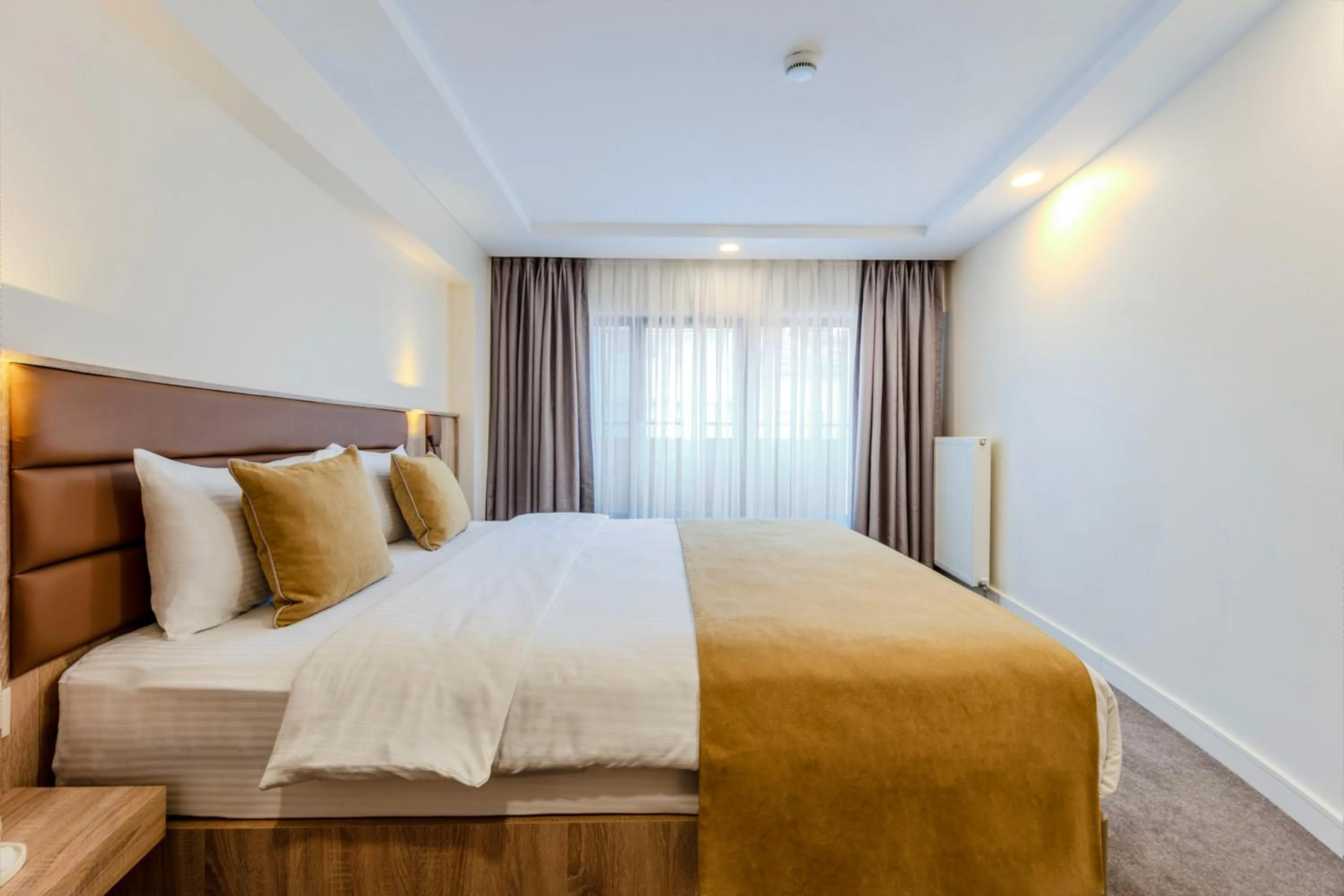 Bed in Roys Hotel & Suites