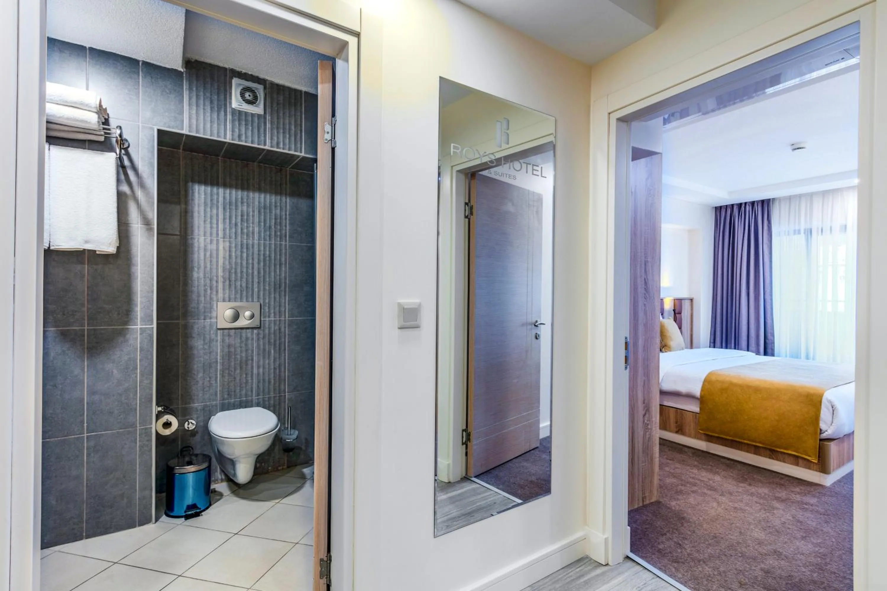 Toilet, Bed in Roys Hotel & Suites