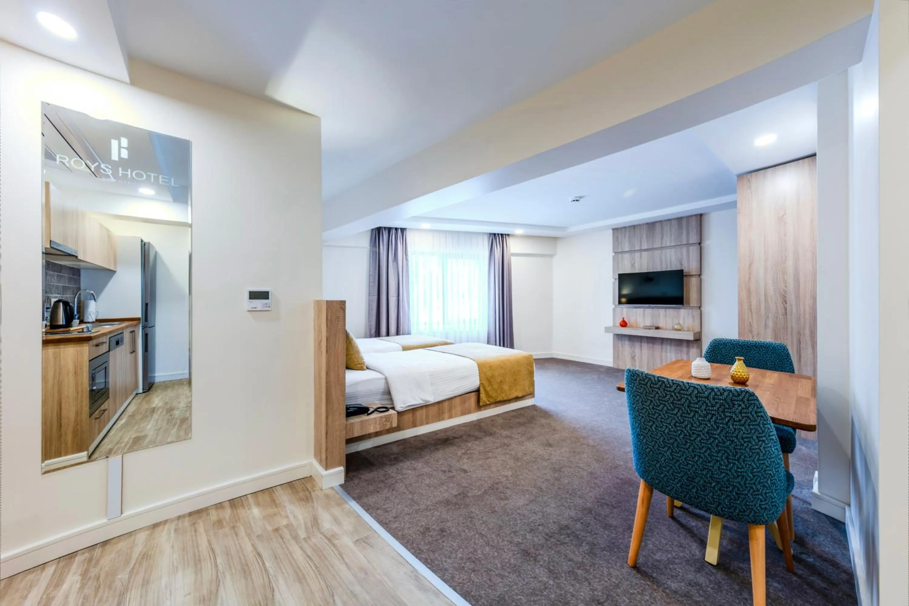 Bed in Roys Hotel & Suites