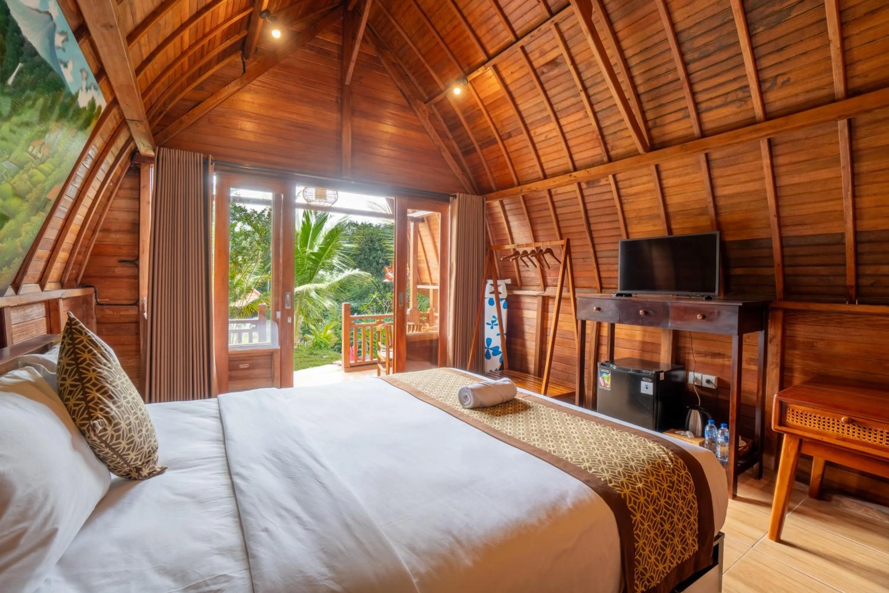 Communal lounge/ TV room, Bed in Puri Kurnia Ayu