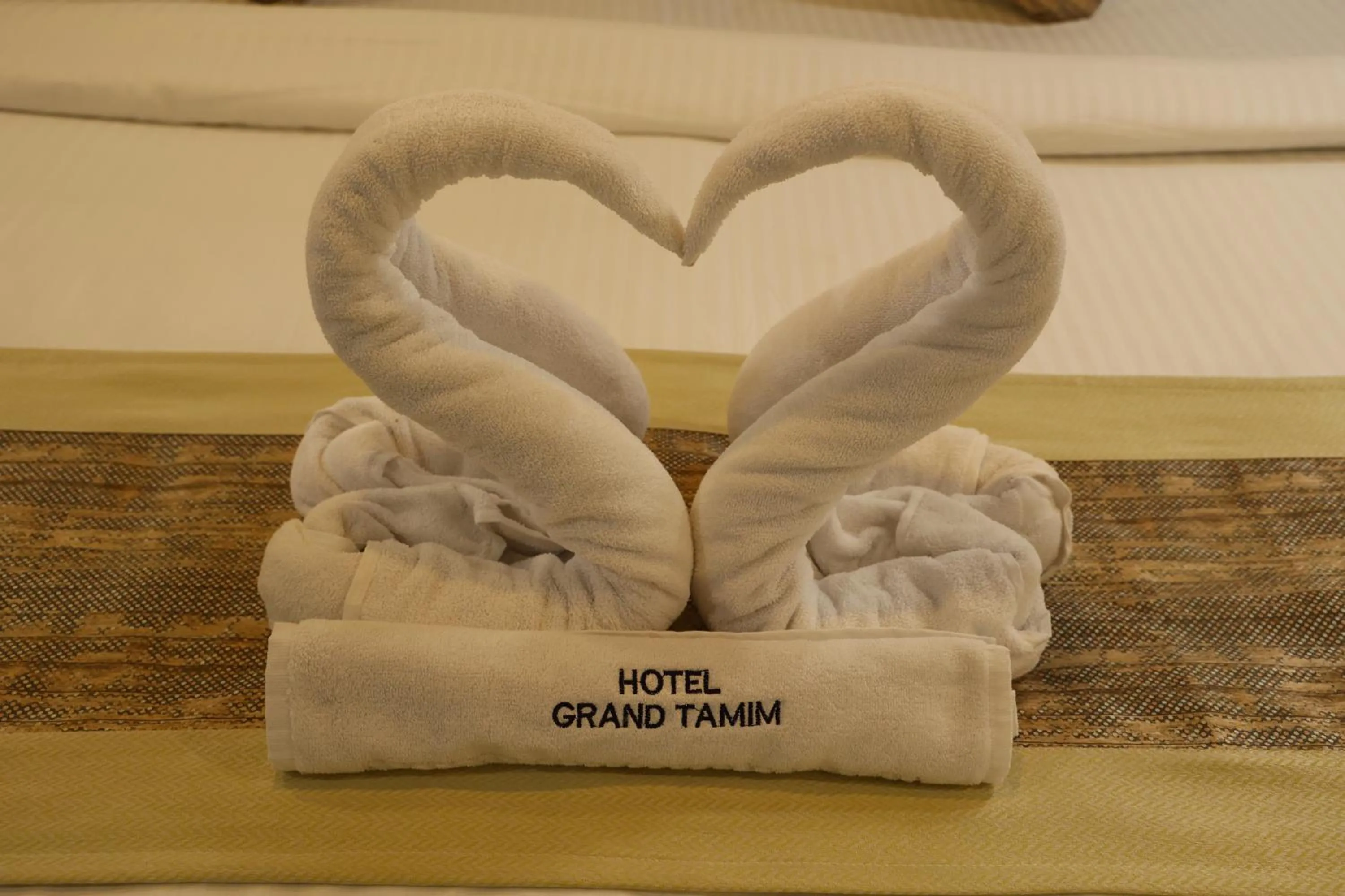 towels, Bed in Grand Tamim Hotel