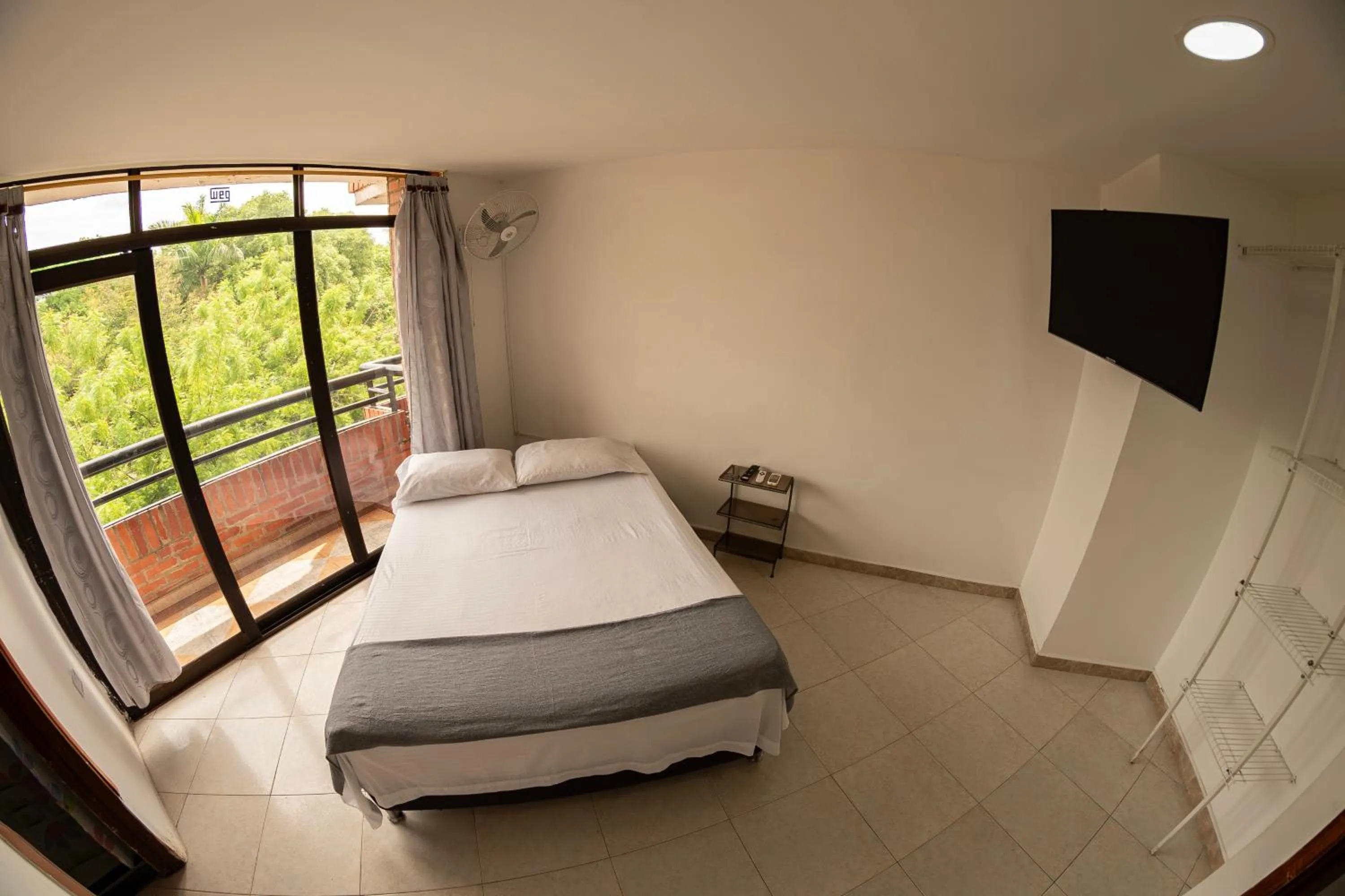 Communal lounge/ TV room, Bed in Hotel Santander Plaza