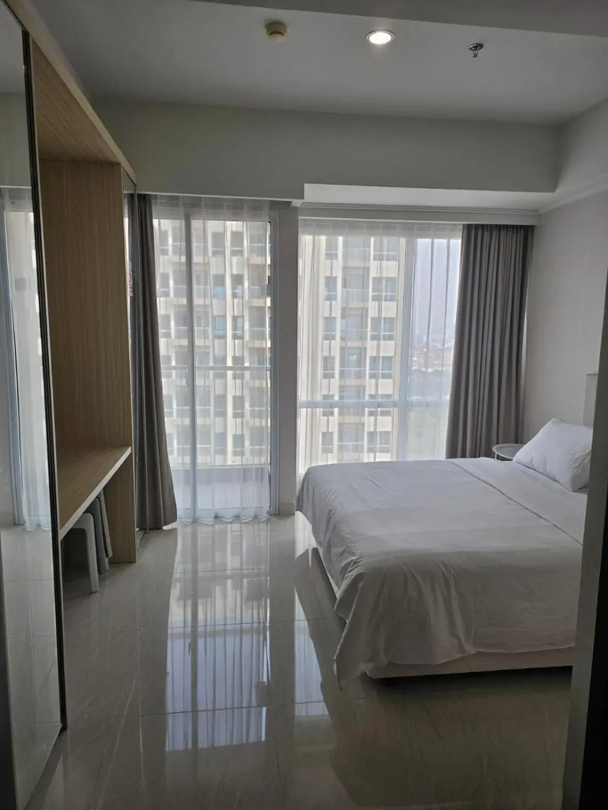 Bed in Green Sedayu Apartment Suite by Ellison Bed in Green Sedayu Apartment Suite by Ellison