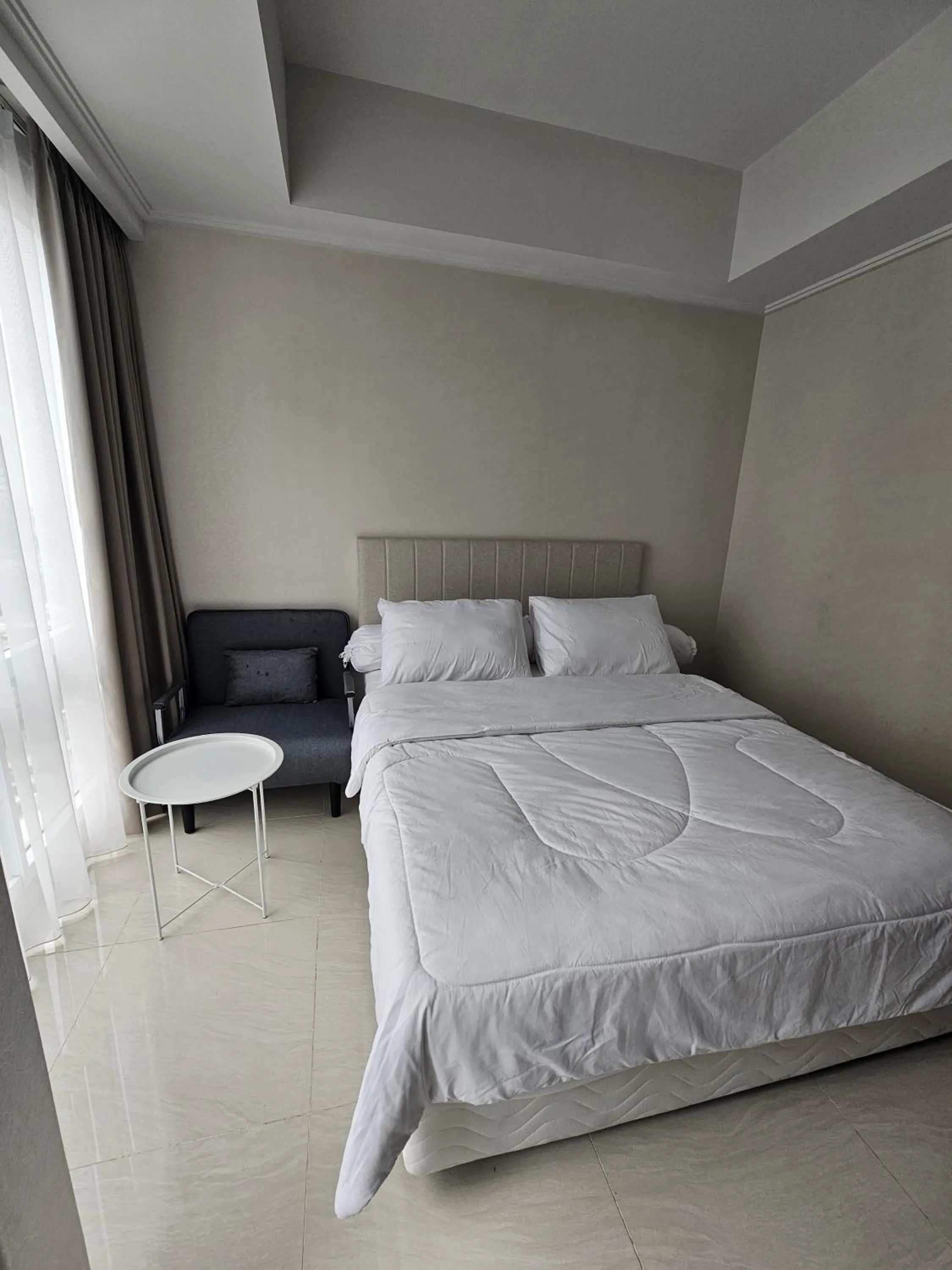 Bed in Green Sedayu Apartment Suite by Ellison