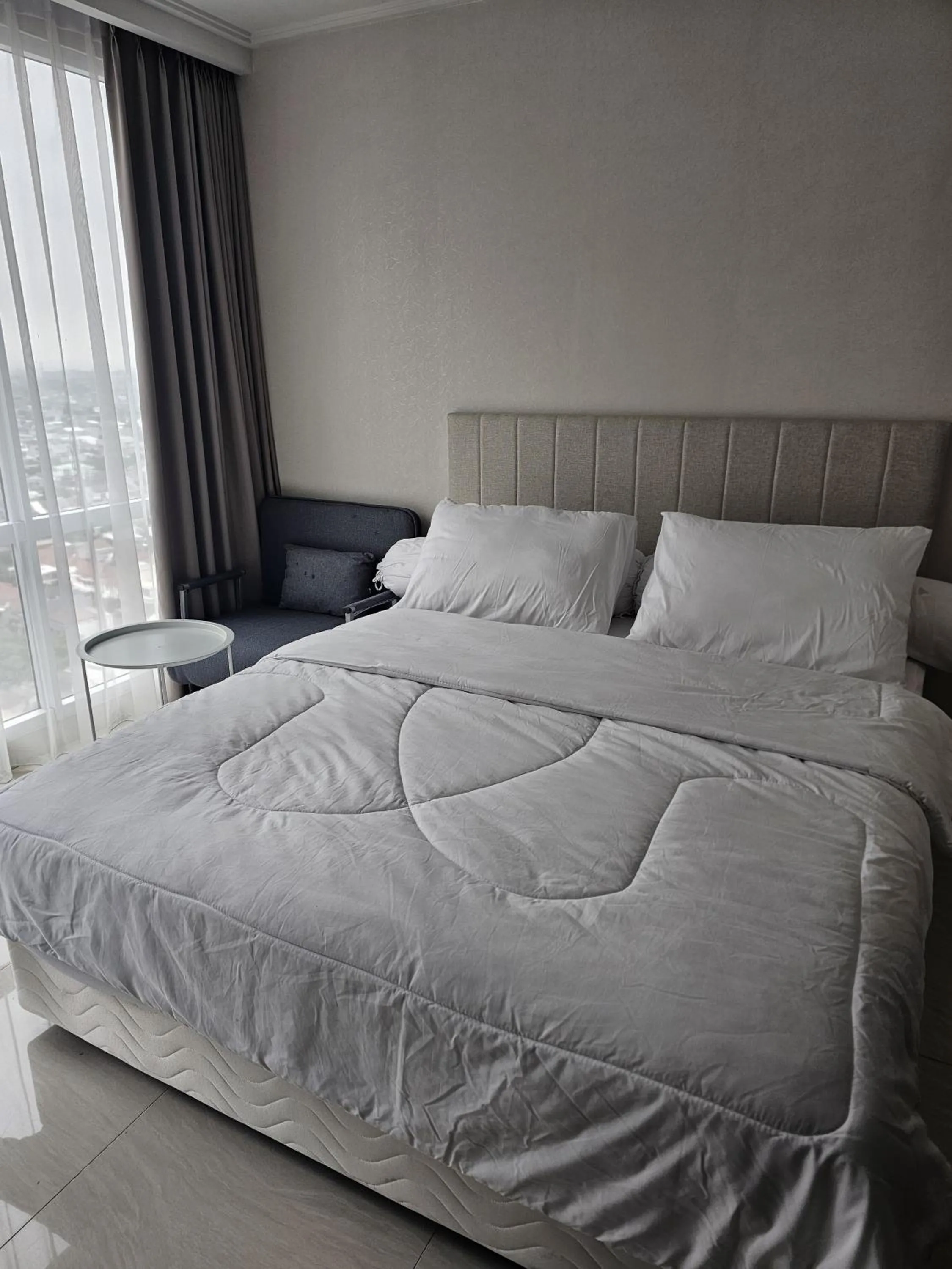 Bed in Green Sedayu Apartment Suite by Ellison