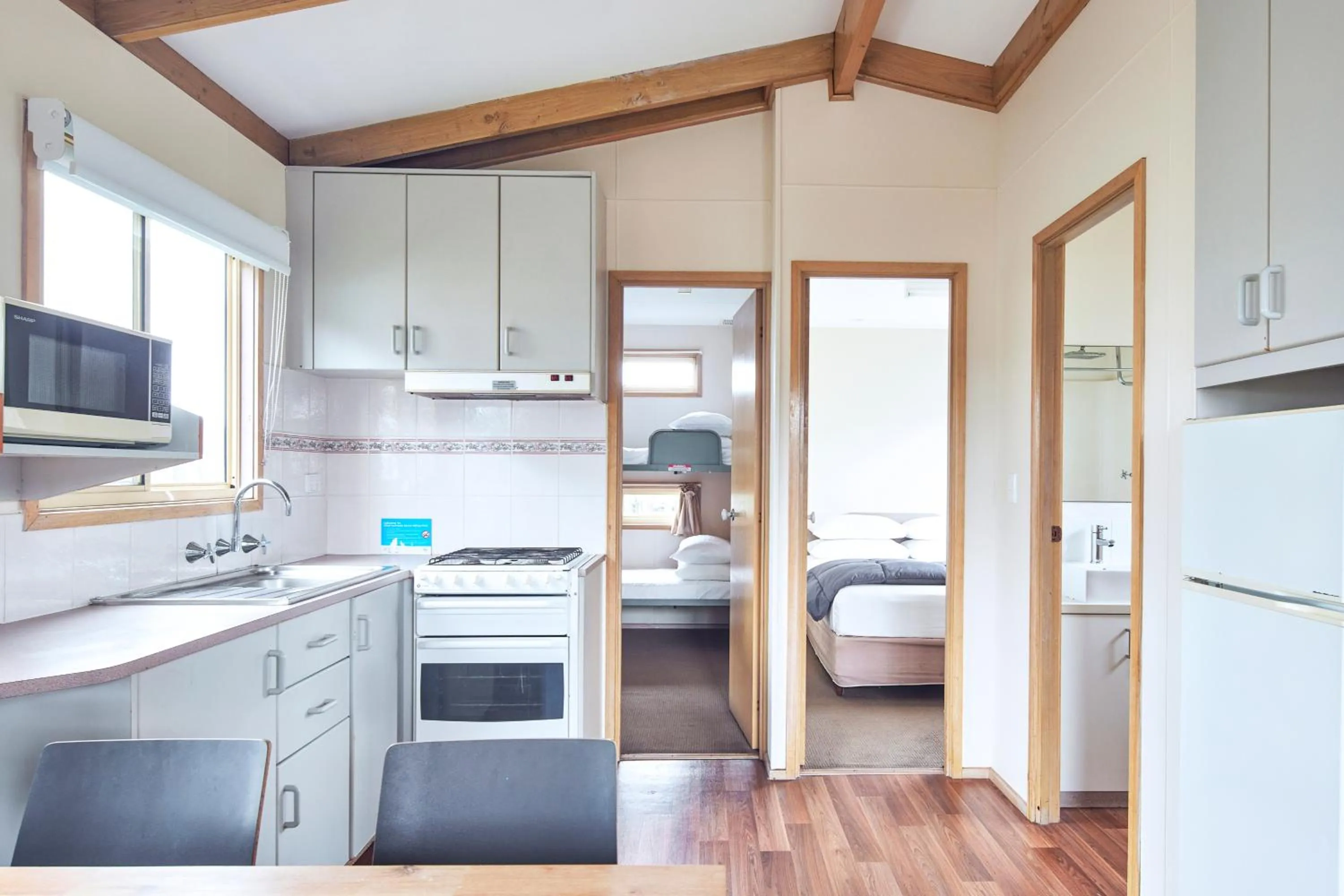 Kitchen or kitchenette, Bed in NRMA Merimbula Beach Holiday Resort