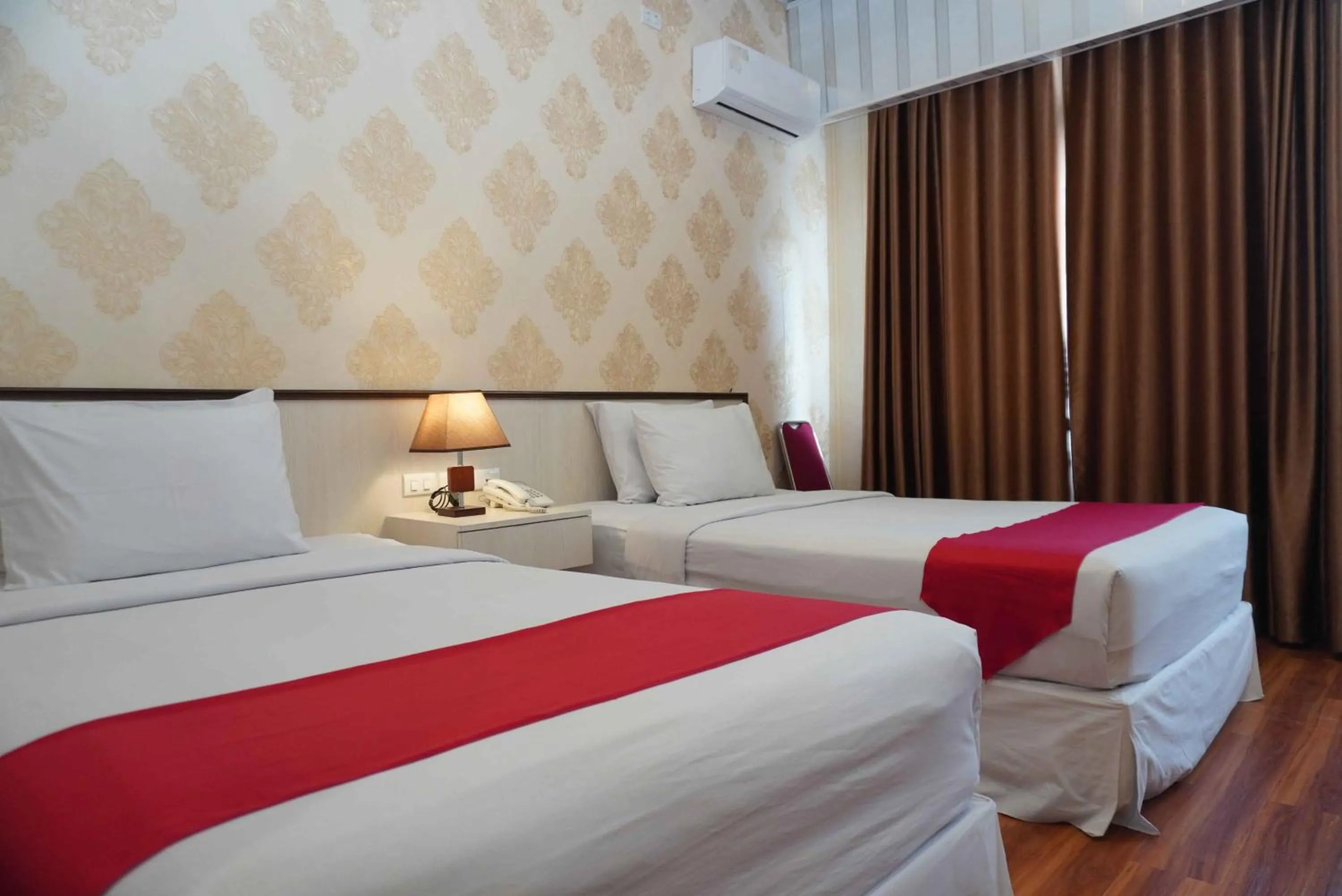 Bed in Grand Tamaro Hotel