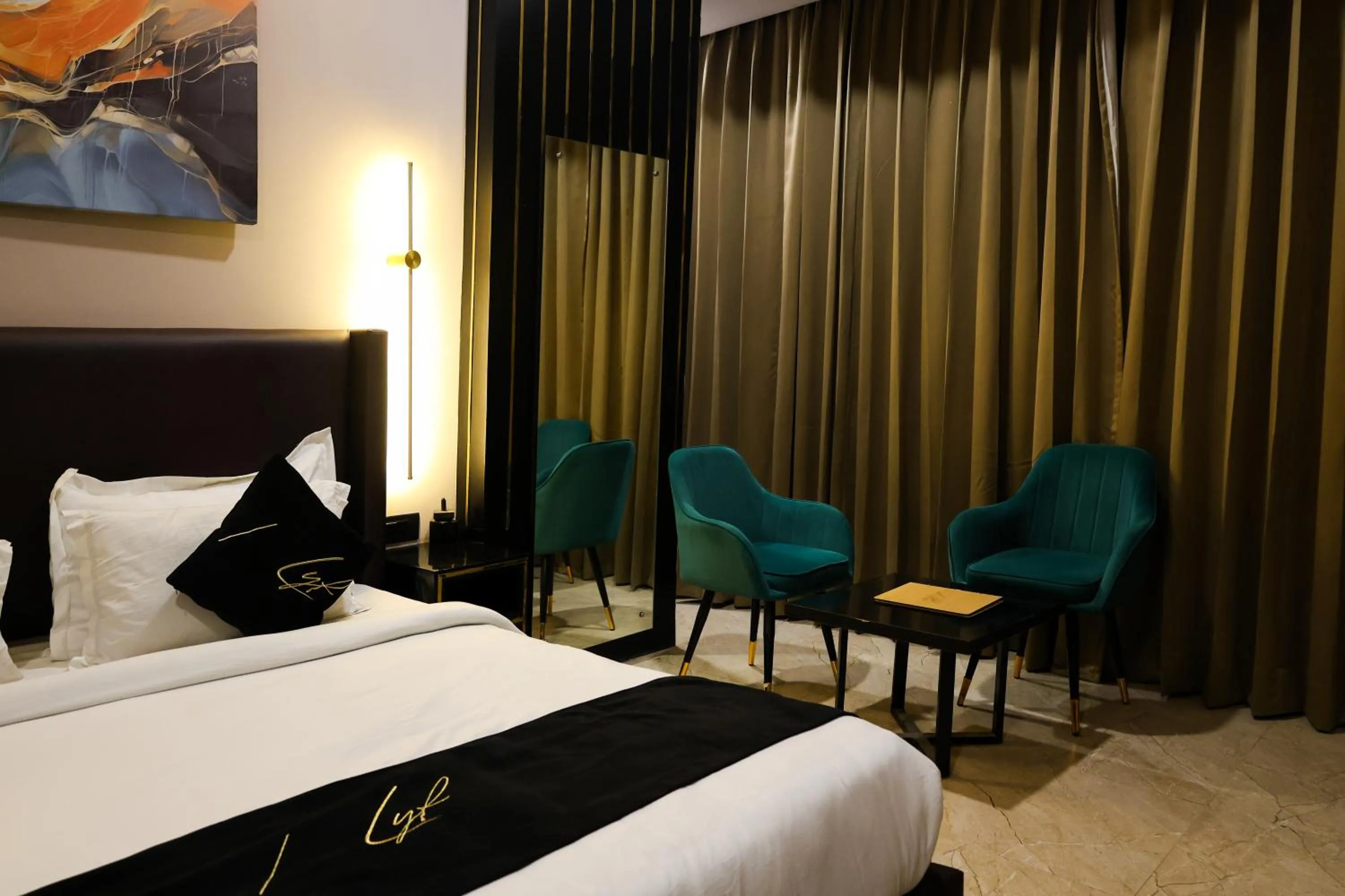 Seating area, Bed in Aquila Grand Suites - Noida Sector 136