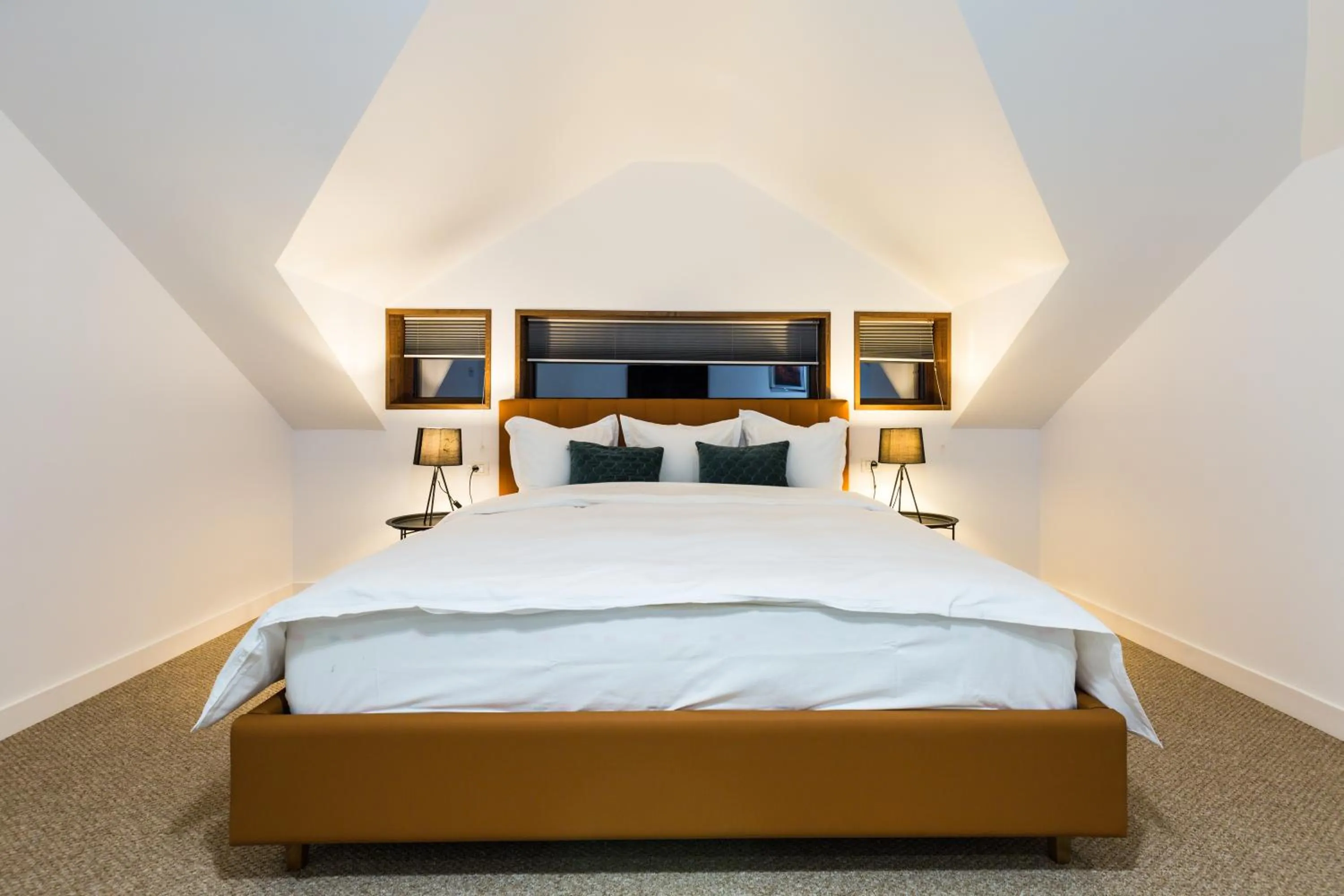 Bed in UpperHouse Suites & More