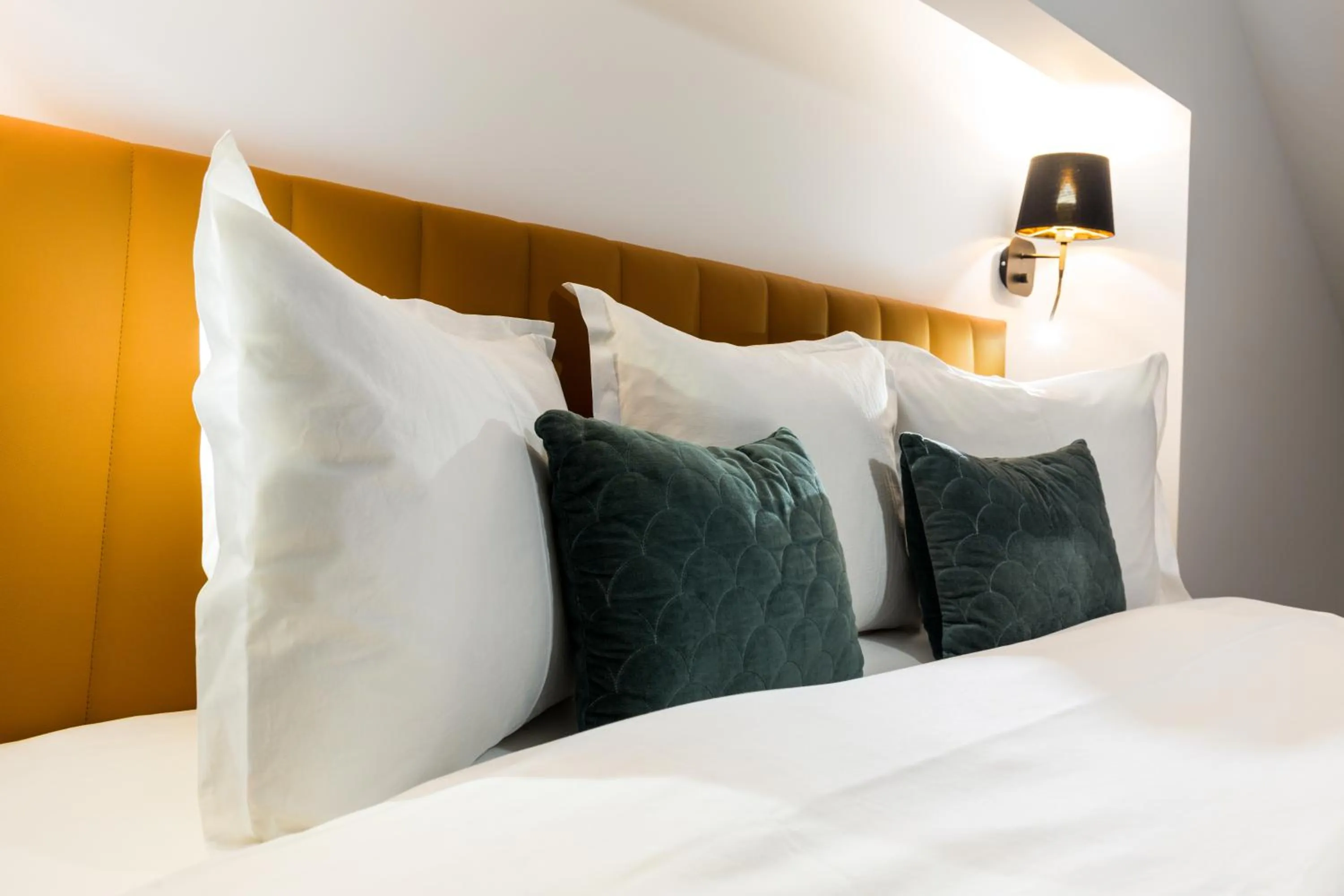 Bed in UpperHouse Suites & More