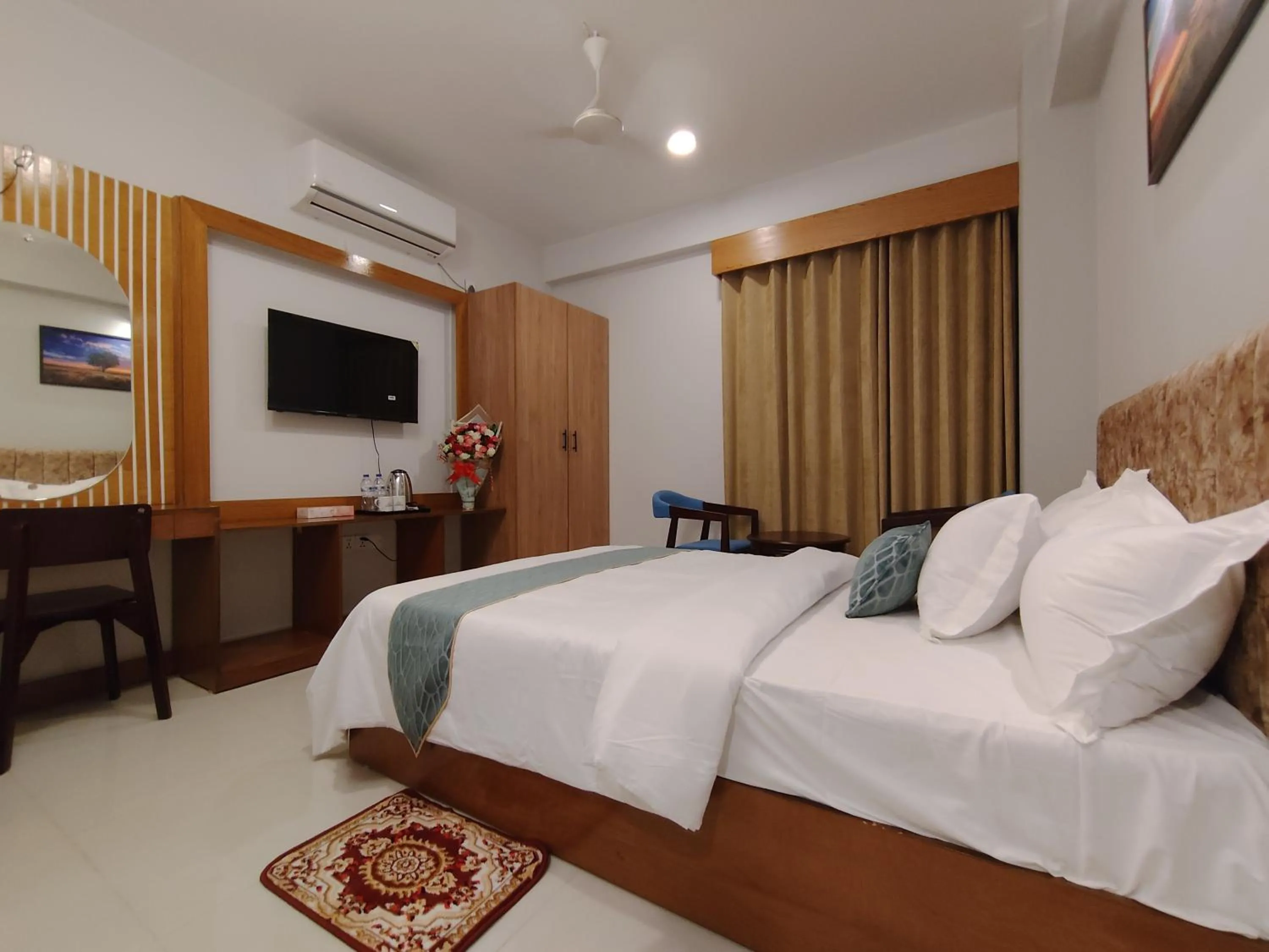 Communal lounge/ TV room, Bed in Sylhet Paradise Inn