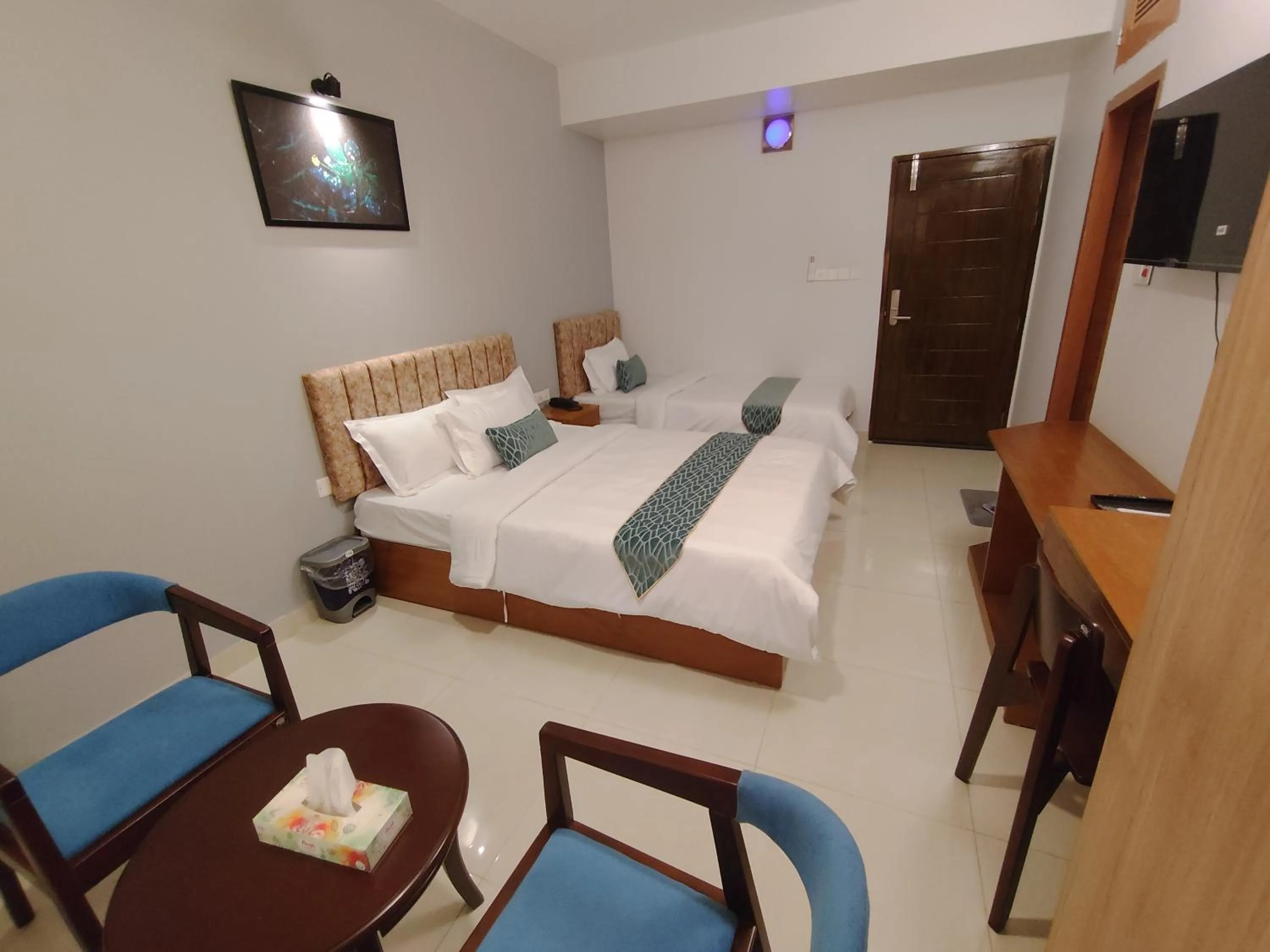 Communal lounge/ TV room, Bed in Sylhet Paradise Inn