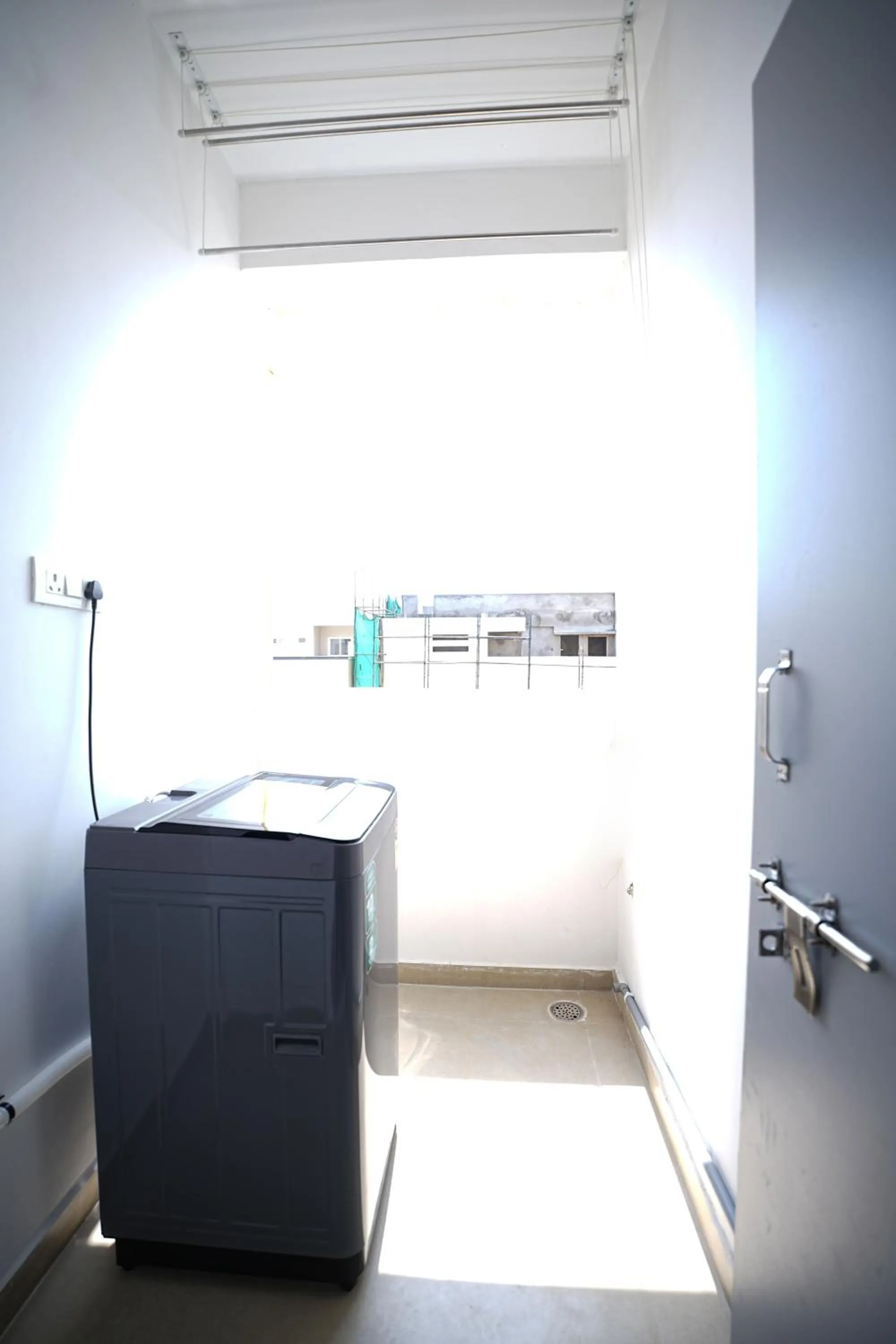 washing machine in Yellow Bells Studios And Suites