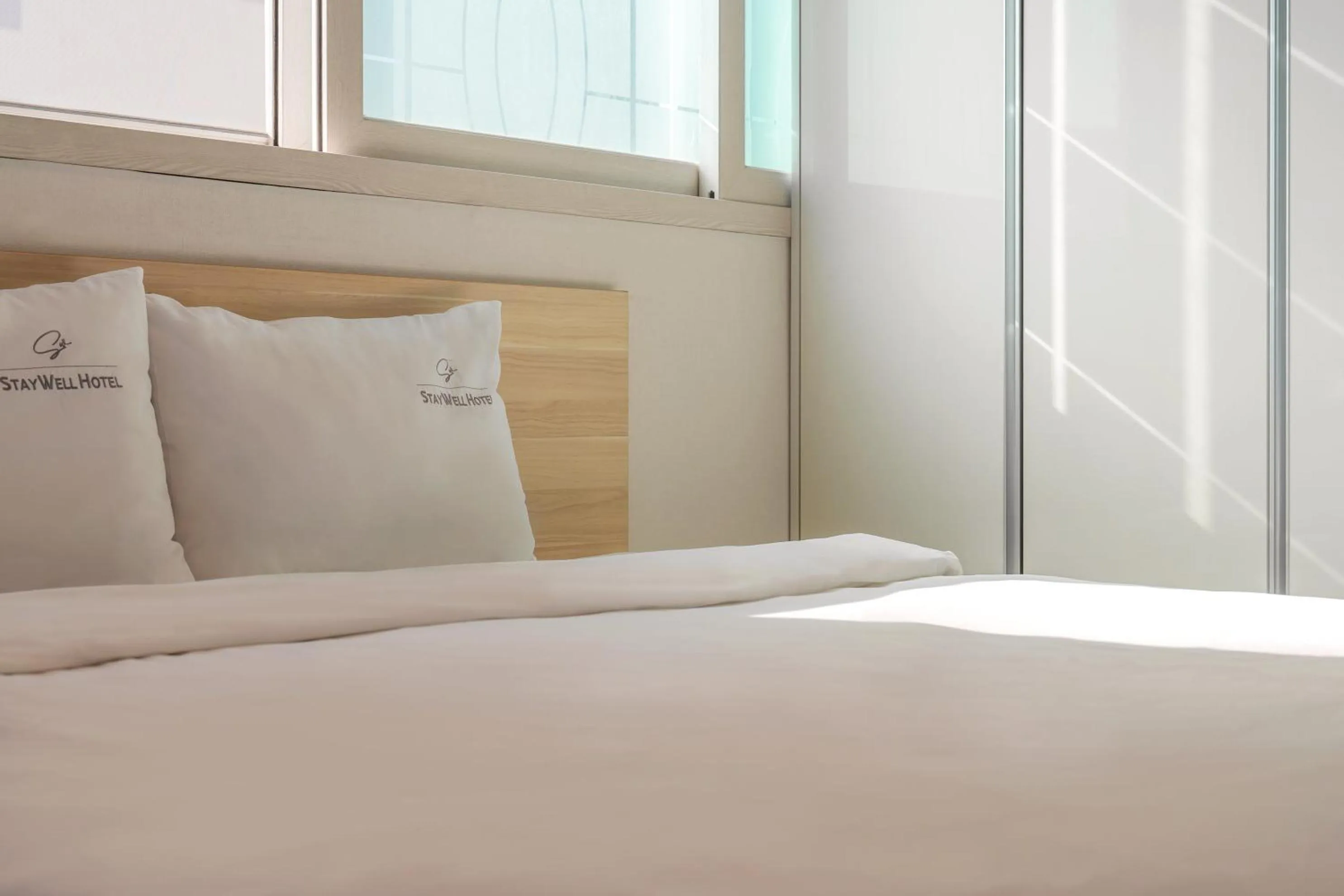 Bed in Staywell Hotel