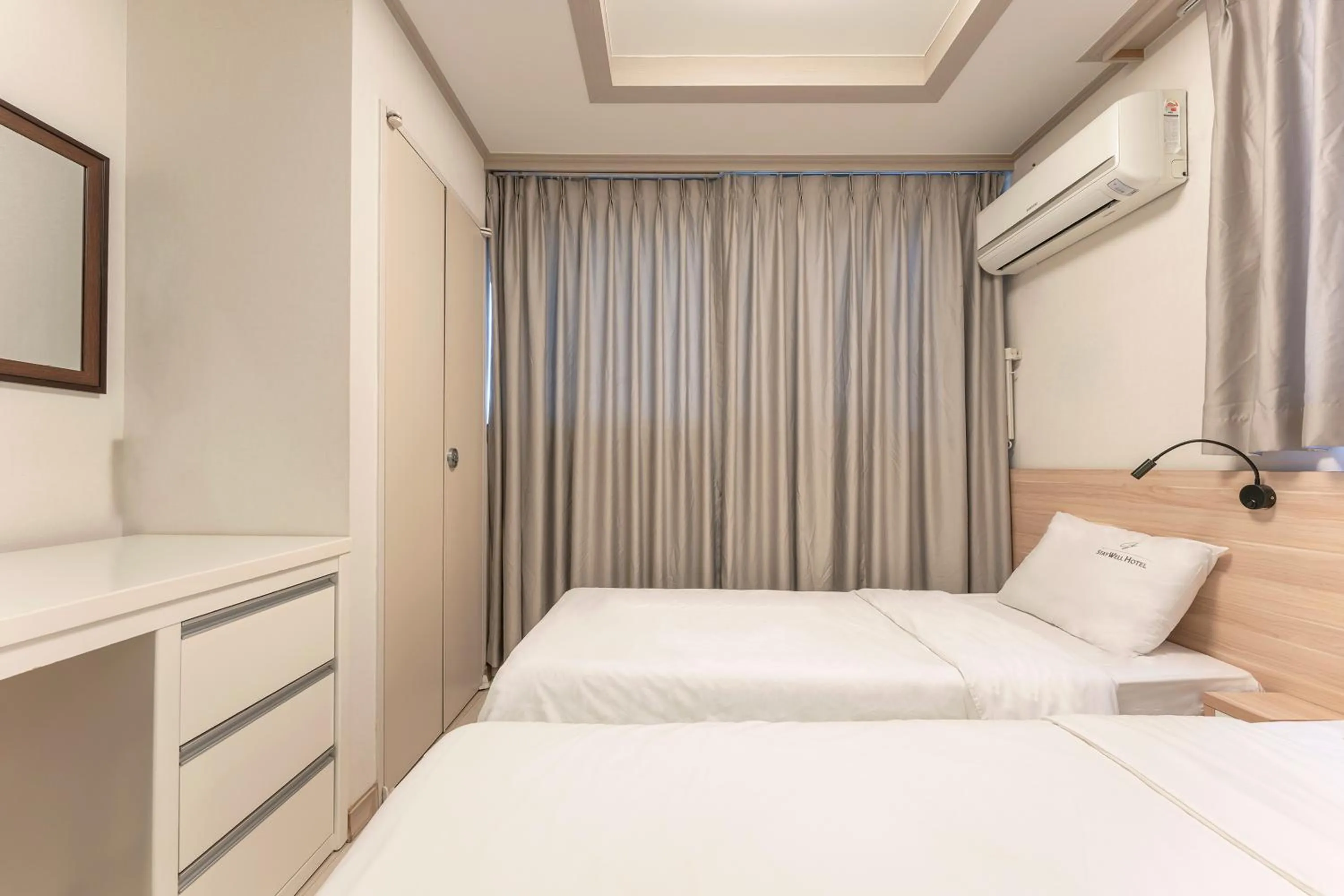 Bed in Staywell Hotel